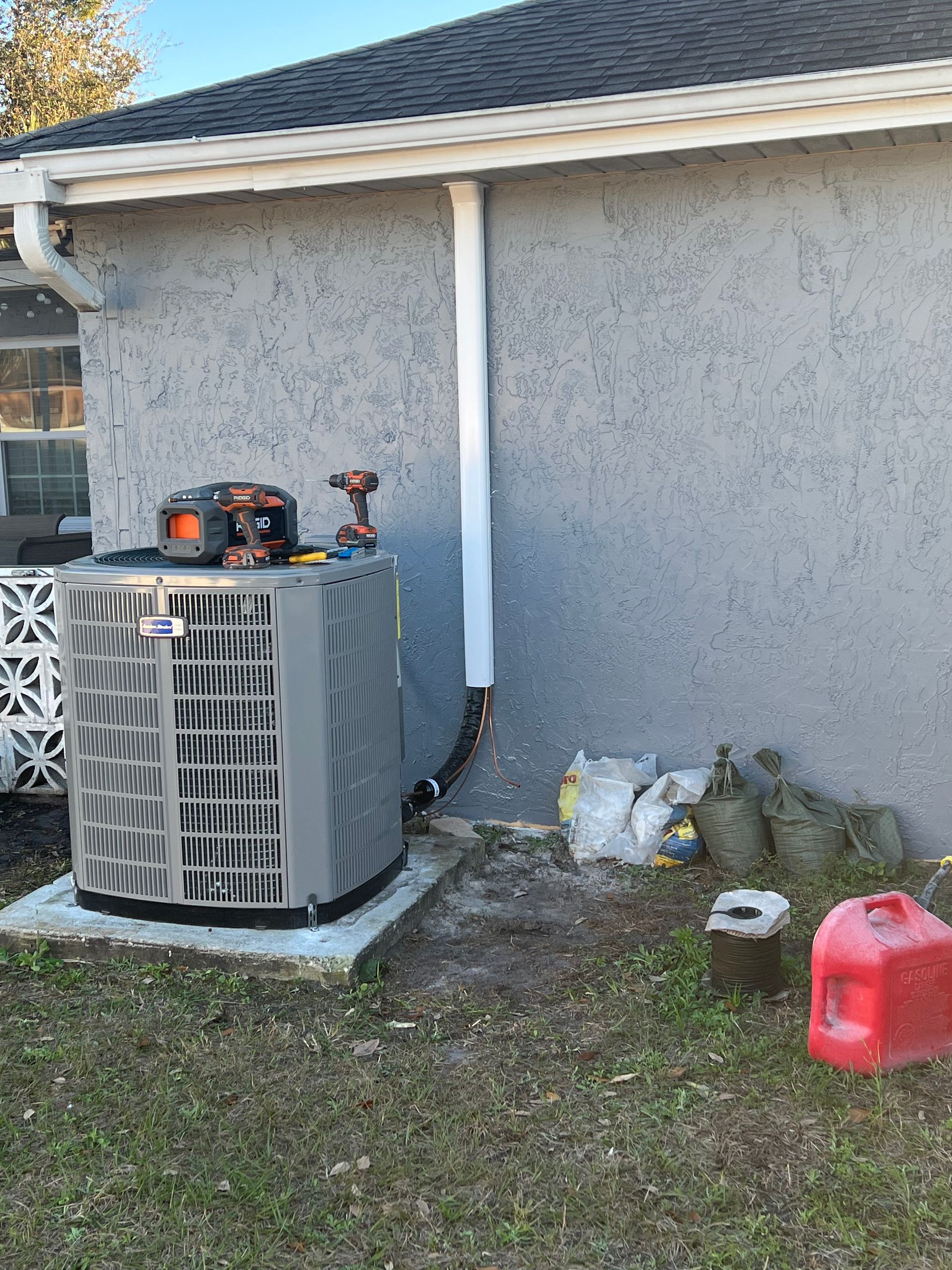 an air conditioner is sitting on the side of a house .