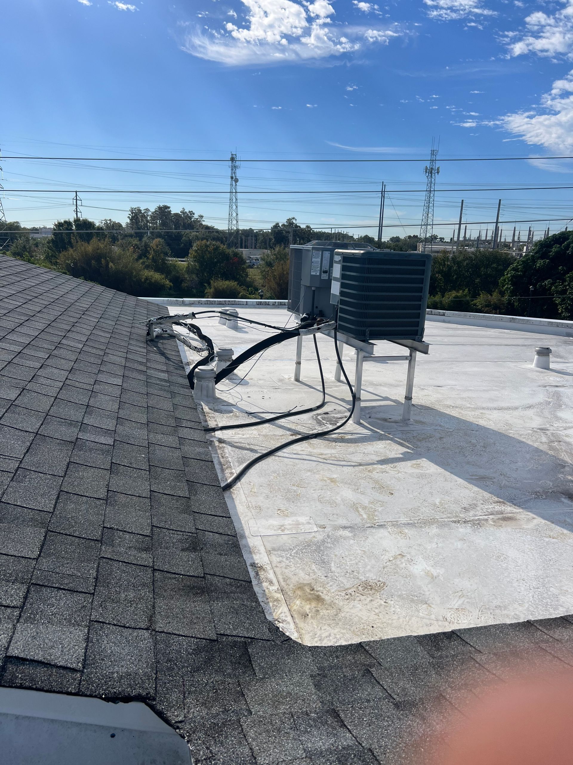 a white roof with a black air conditioner on top of it .