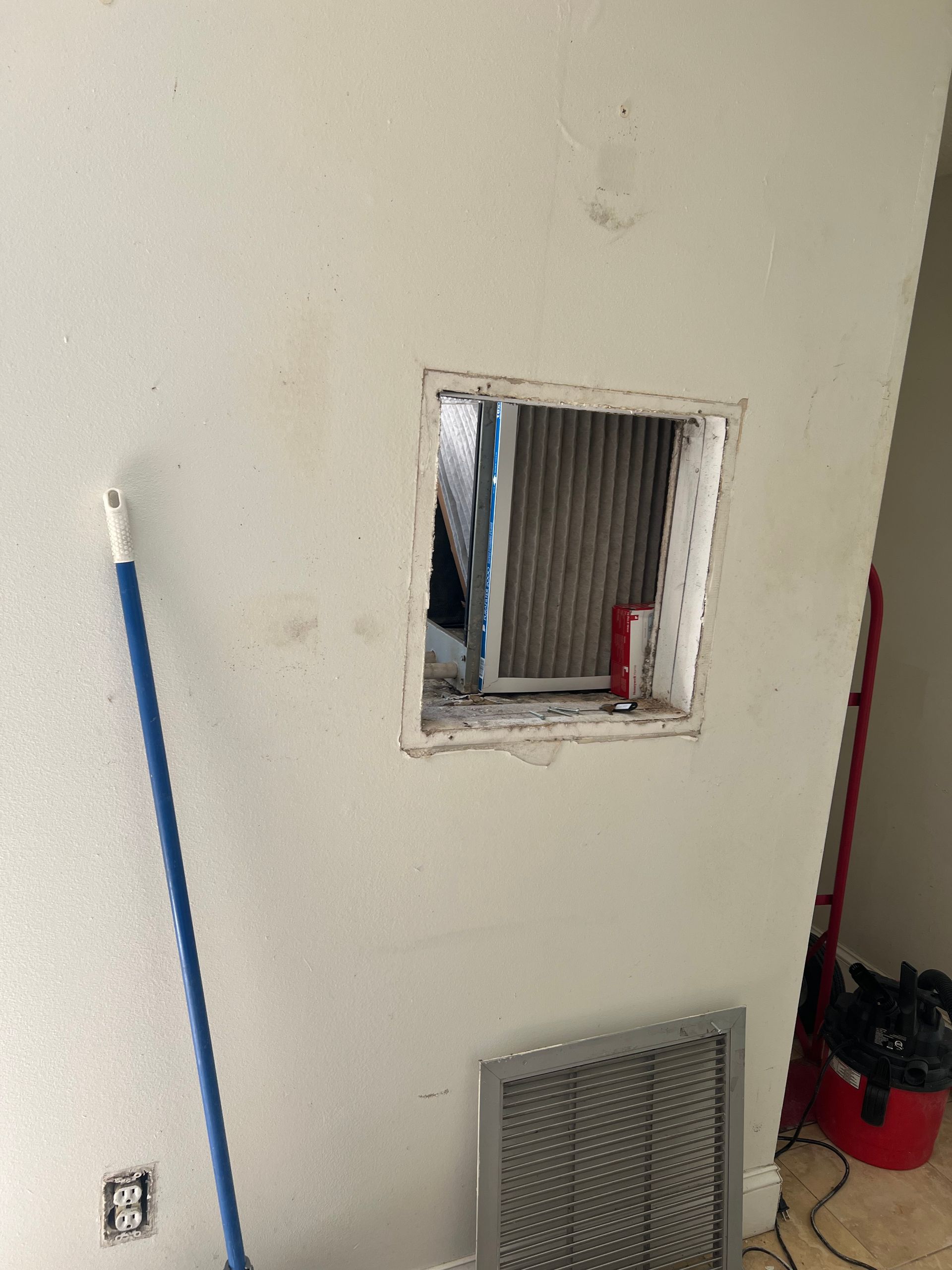 there is a hole in the wall that looks like a window .
