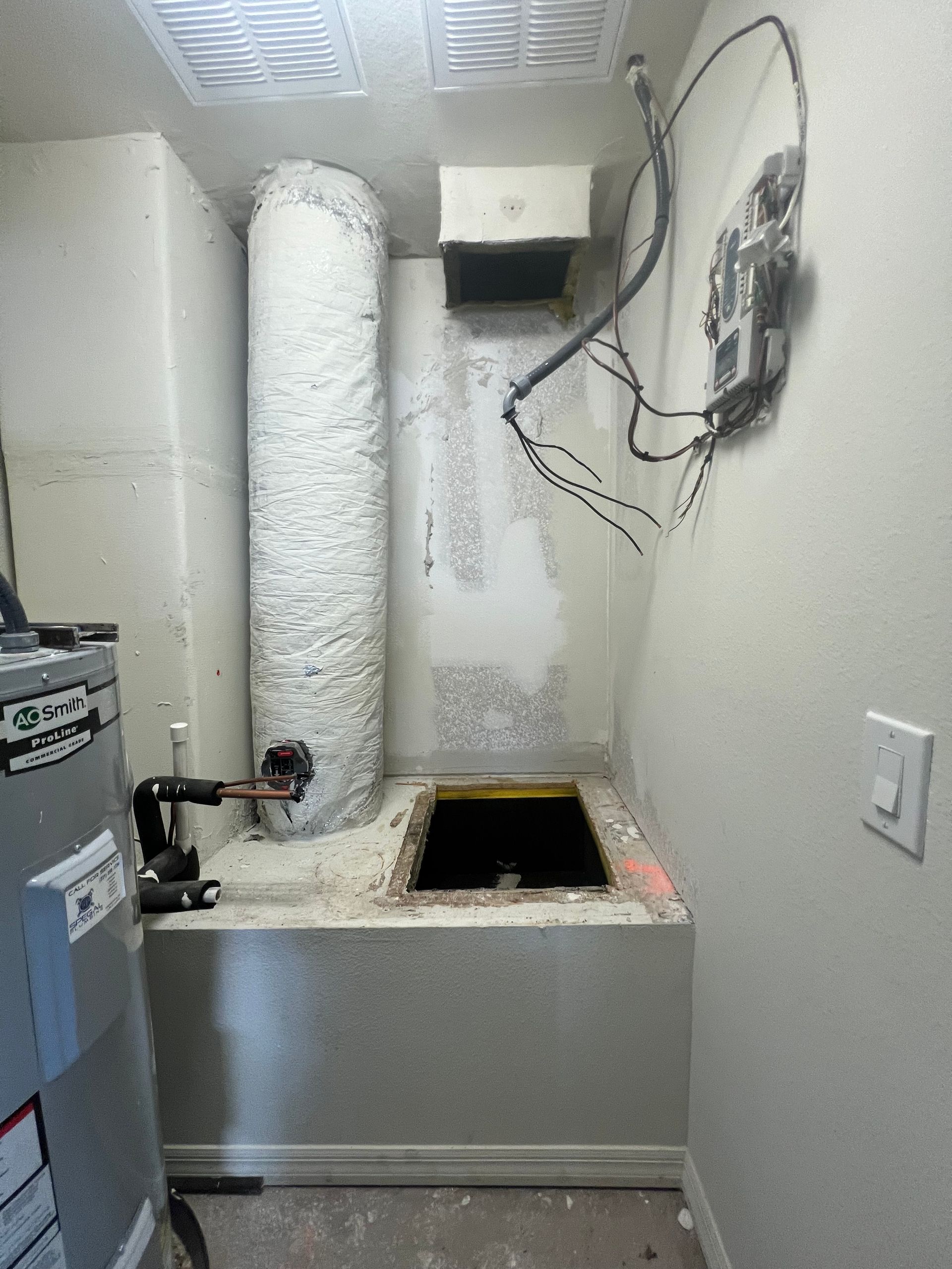 there is a hole in the wall in the middle of the room .