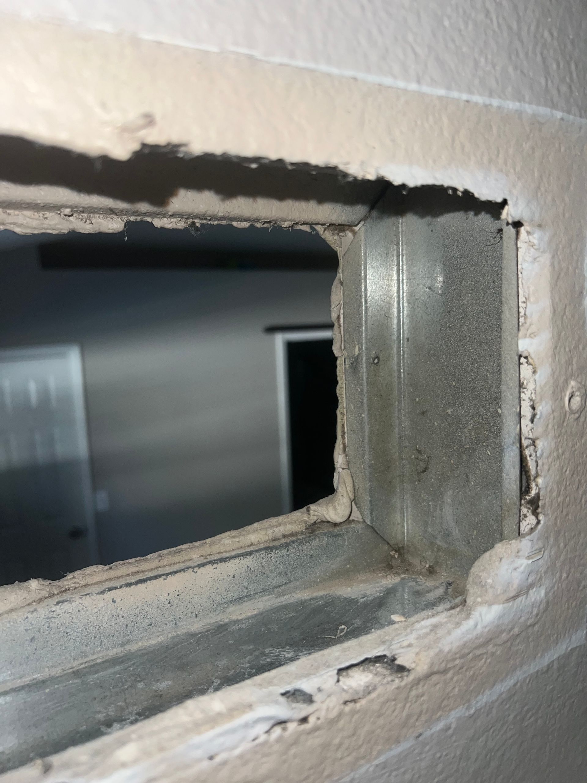 there is a hole in the wall that looks like a window .