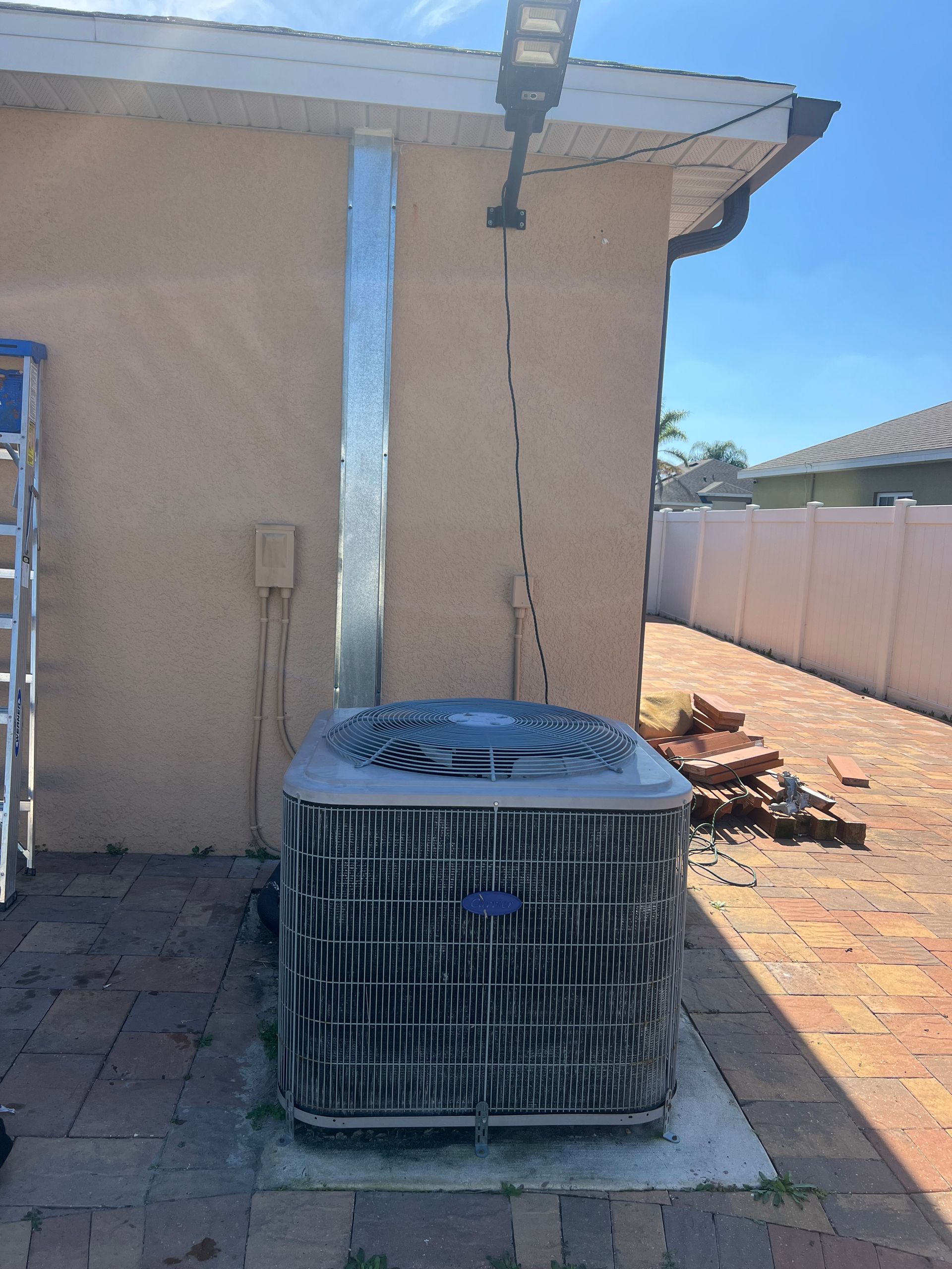 an air conditioner is sitting on the side of a house .