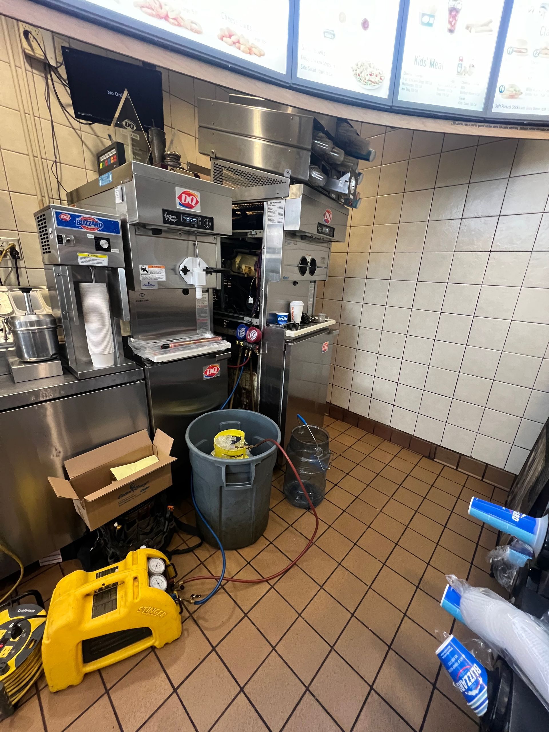 the inside of a fast food restaurant with a lot of cleaning equipment .