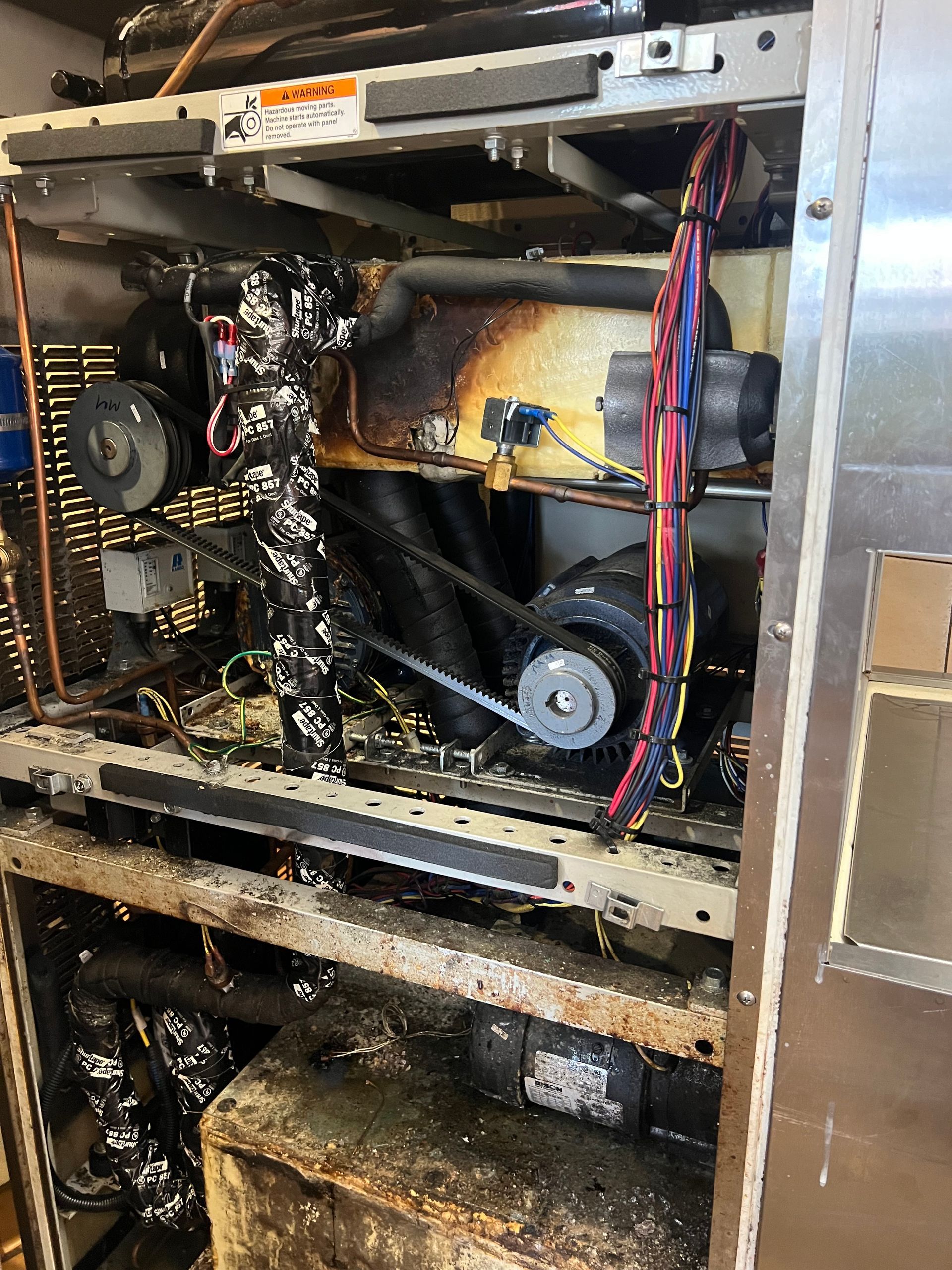 the inside of a dirty refrigerator with the door open .