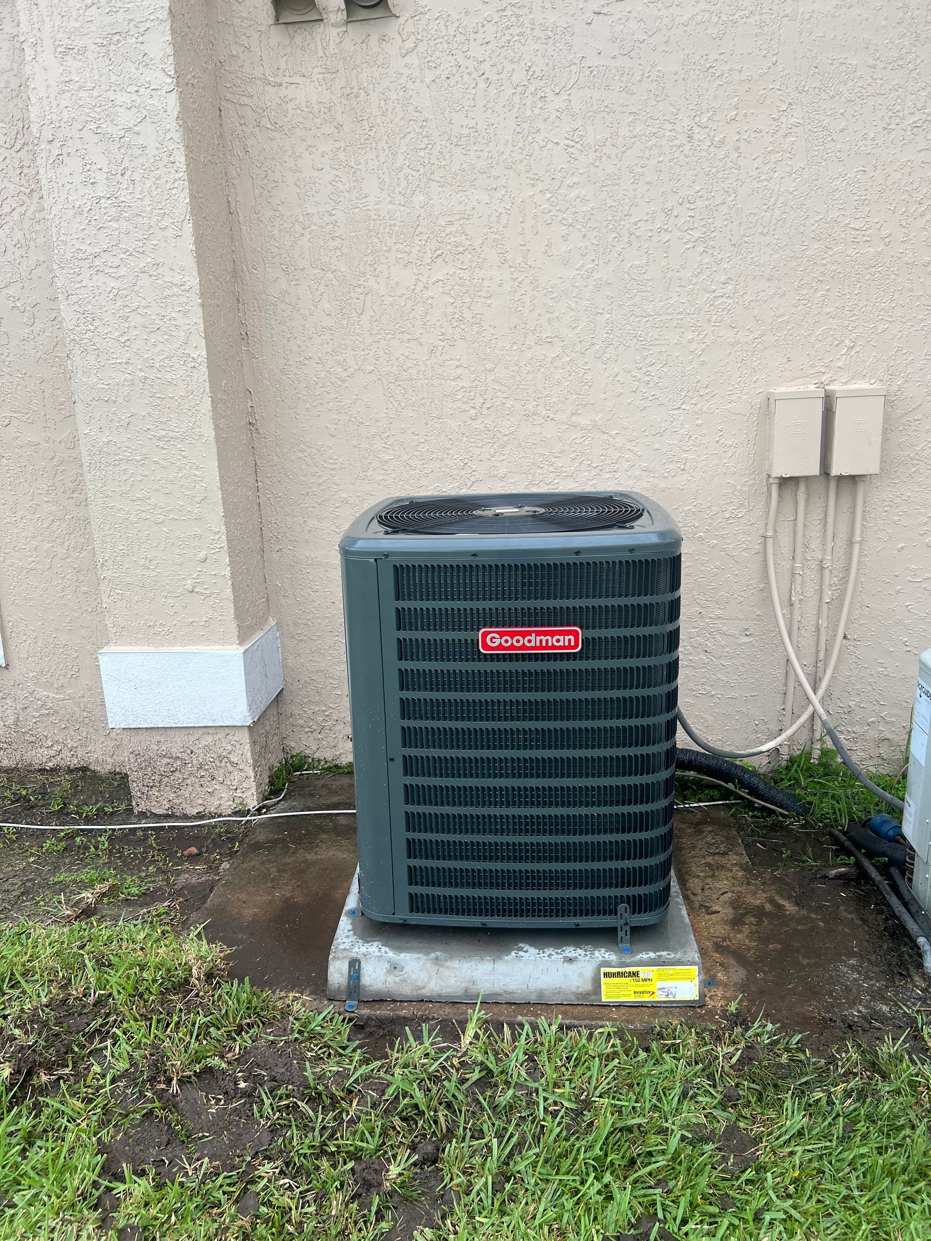 a large air conditioner is sitting on the side of a building .