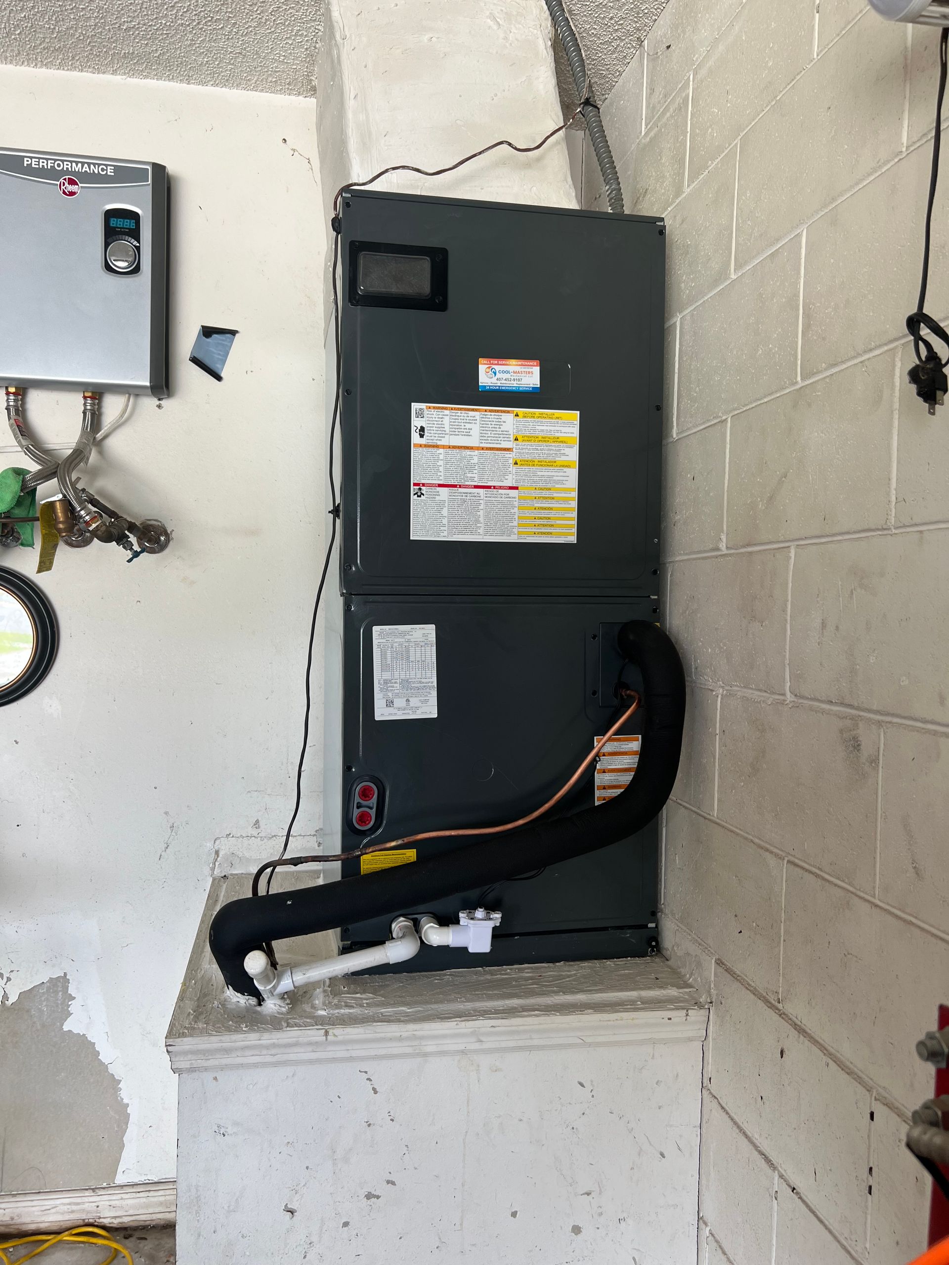 a refrigerator is sitting on a shelf in a room next to a brick wall .