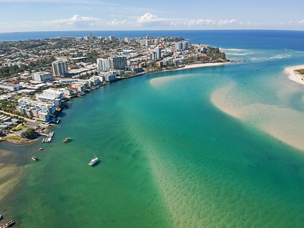 Aerial View of a Coastal Town With a River Flowing Into the Ocean — Reynolds Built In Golden Beach, QLD