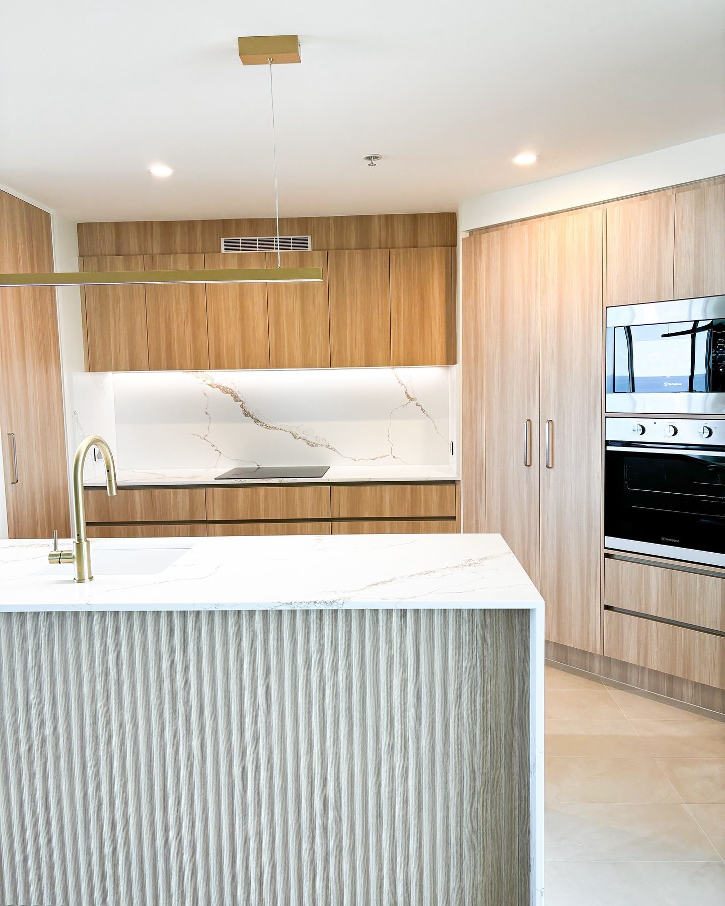 A Kitchen With Wooden Cabinets And A White Counter Top — Reynolds Built In Dicky Beach, QLD