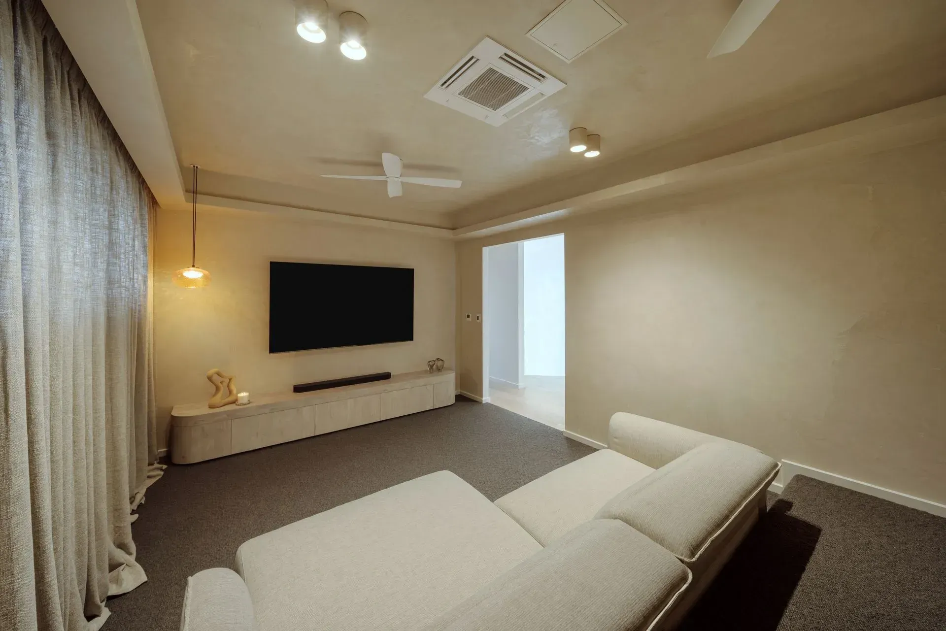 A Living Room With A Couch, Television, And Ceiling Fan — Reynolds Built In Dicky Beach, QLD