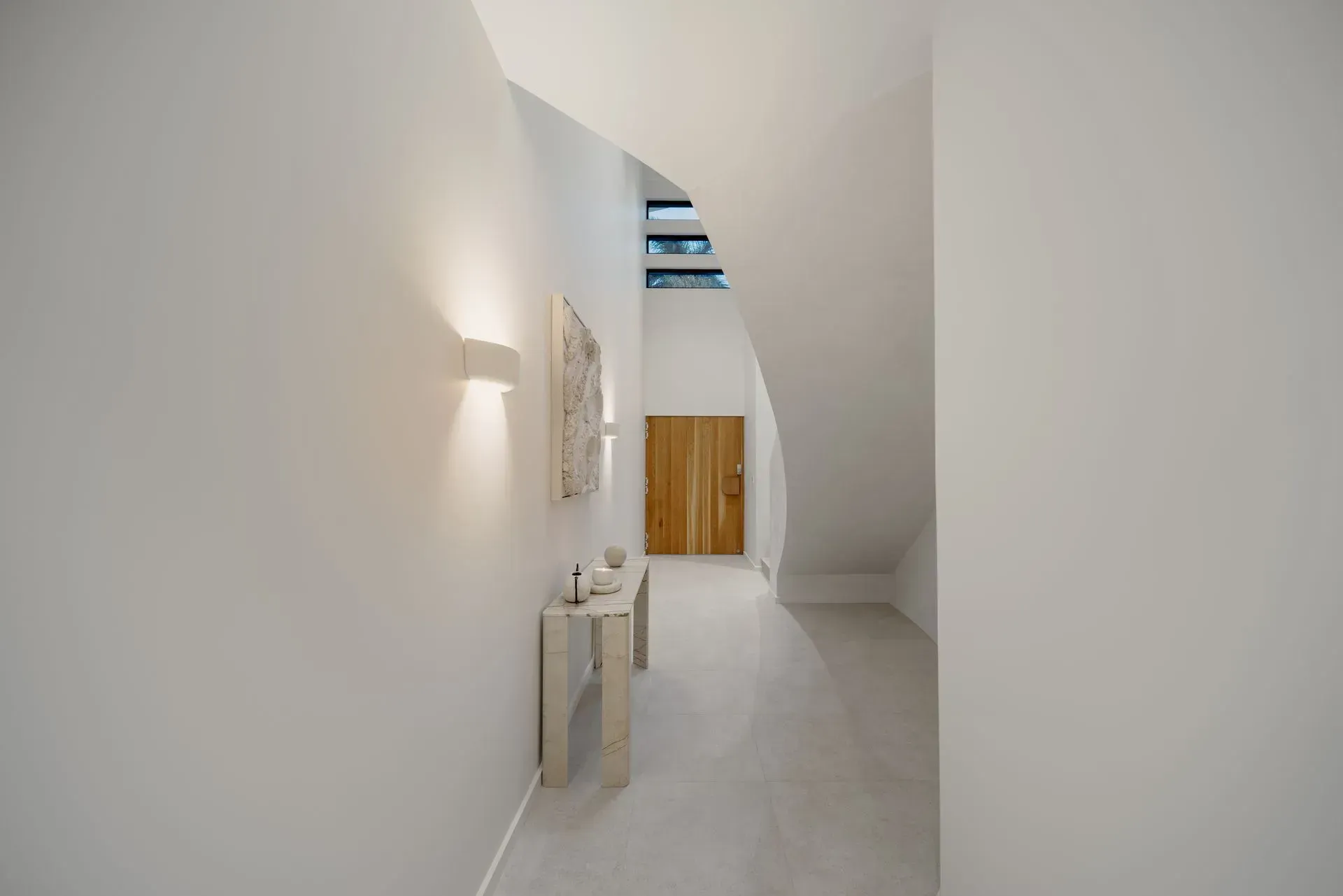 A Hallway With A Table And Stairs In A House — Reynolds Built In Dicky Beach, QLD