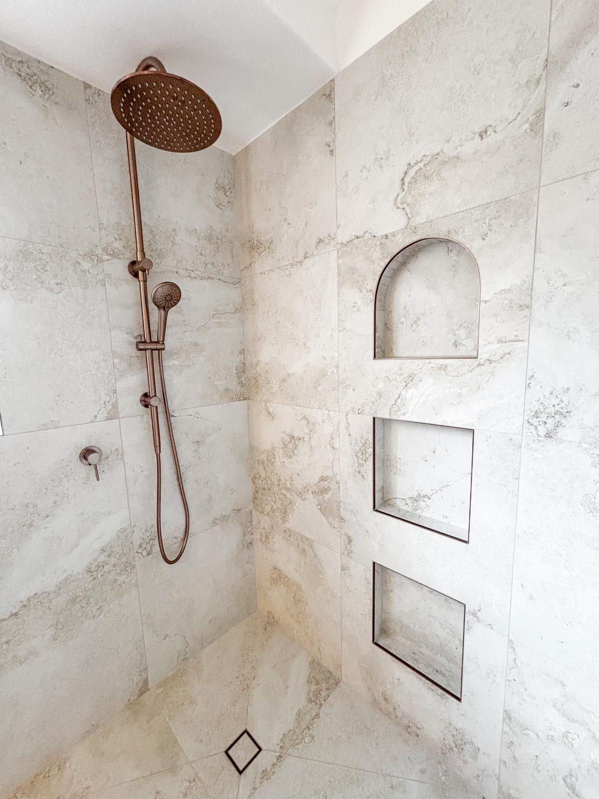 A Shower With Marble-like White and Beige Tiles — Reynolds Built In Dicky Beach, QLD