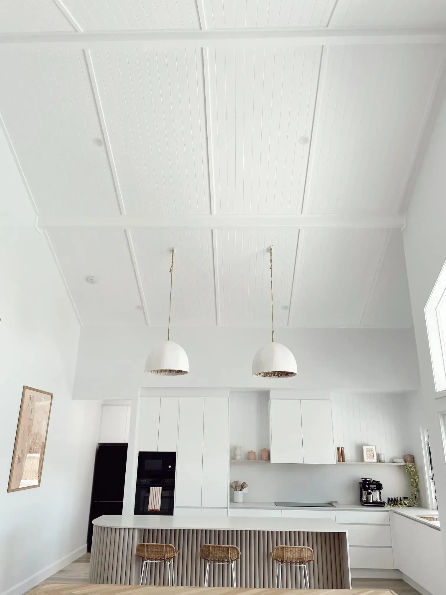 A Kitchen With White Cabinets And A Large Island — Reynolds Built In Dicky Beach, QLD