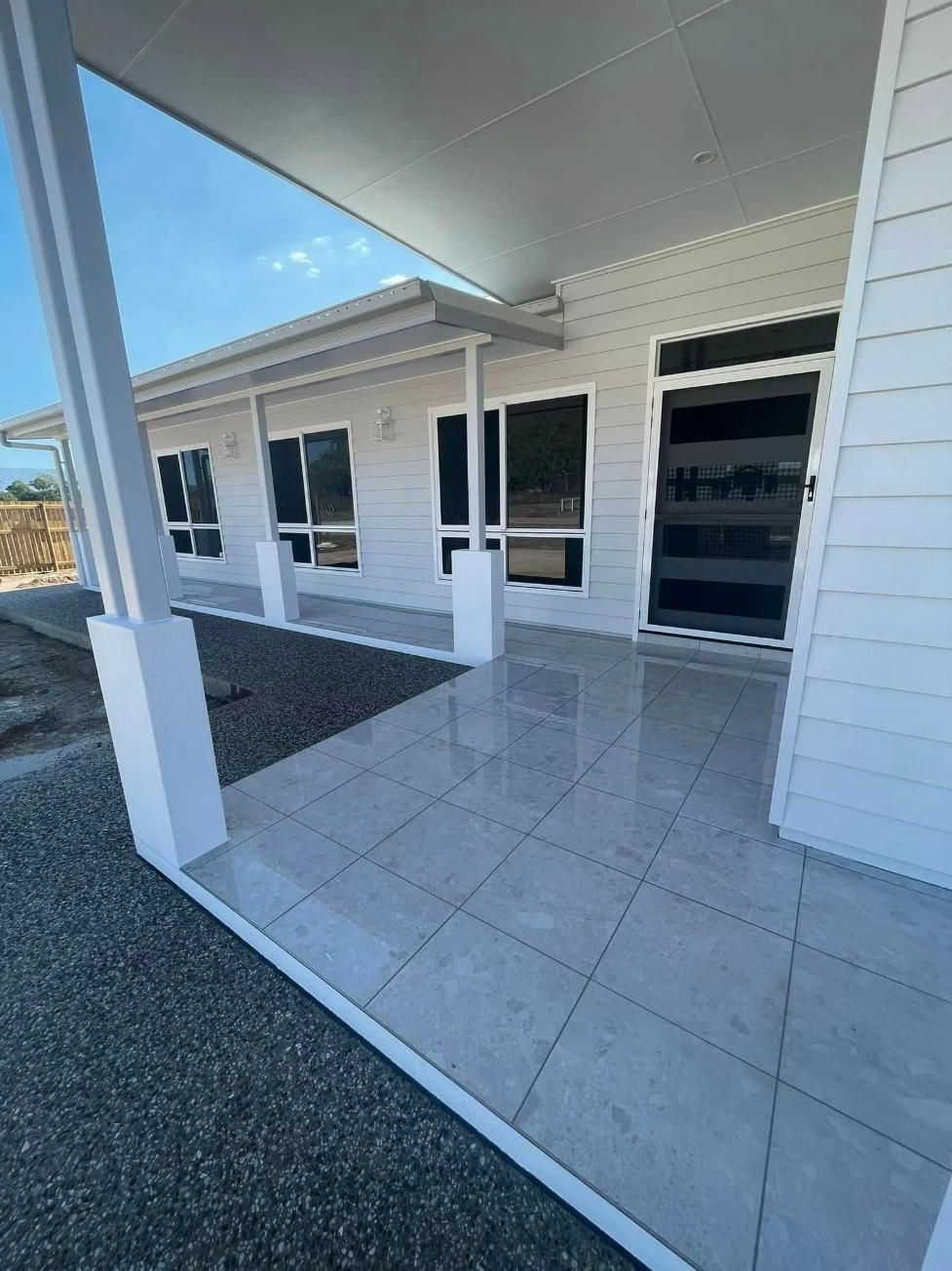A White House With A Covered Porch And A Tiled Floor — Reynolds Built In Dicky Beach, QLD