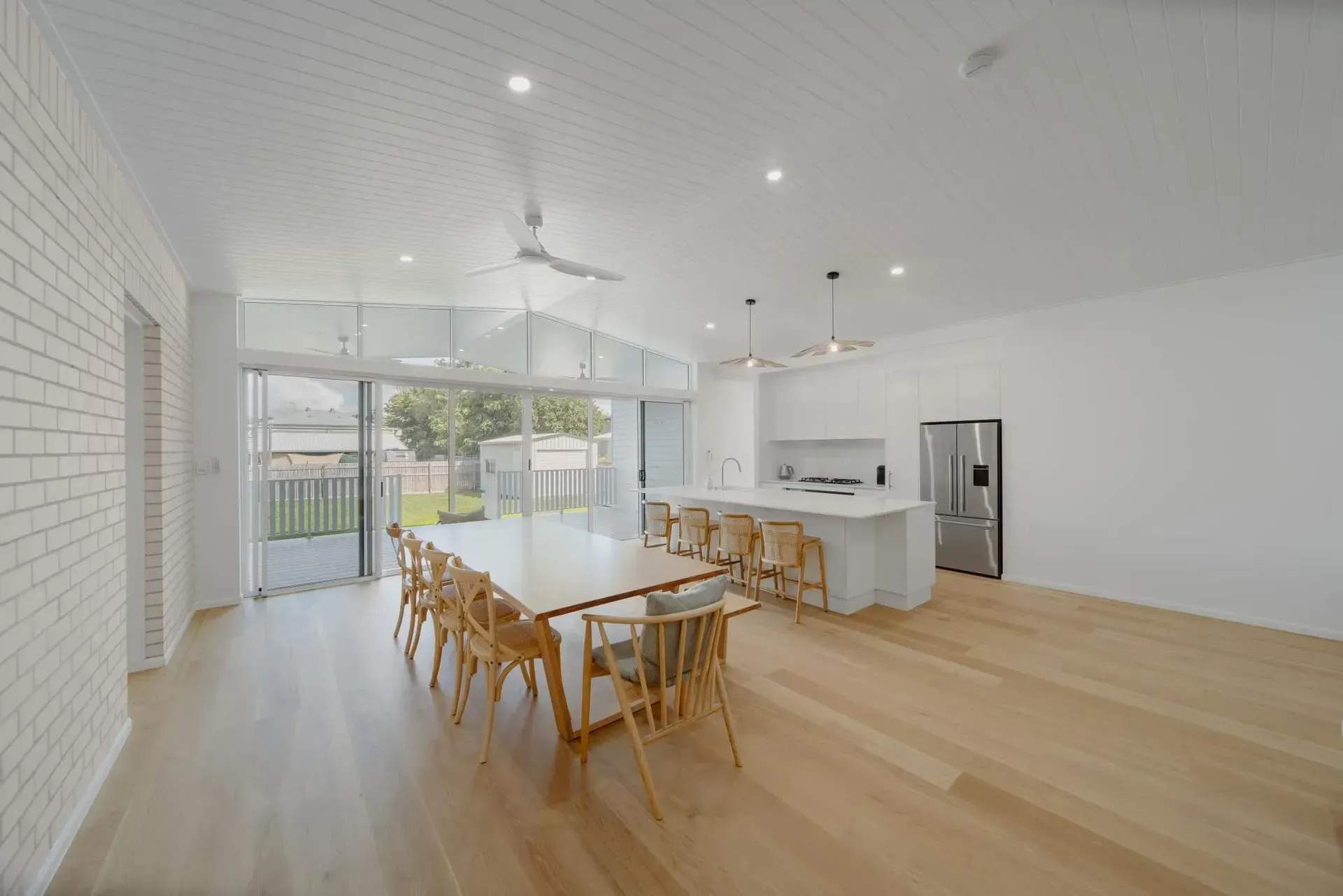 Open-plan Kitchen and Dining Area With Light Wood Floors — Reynolds Built In Dicky Beach, QLD