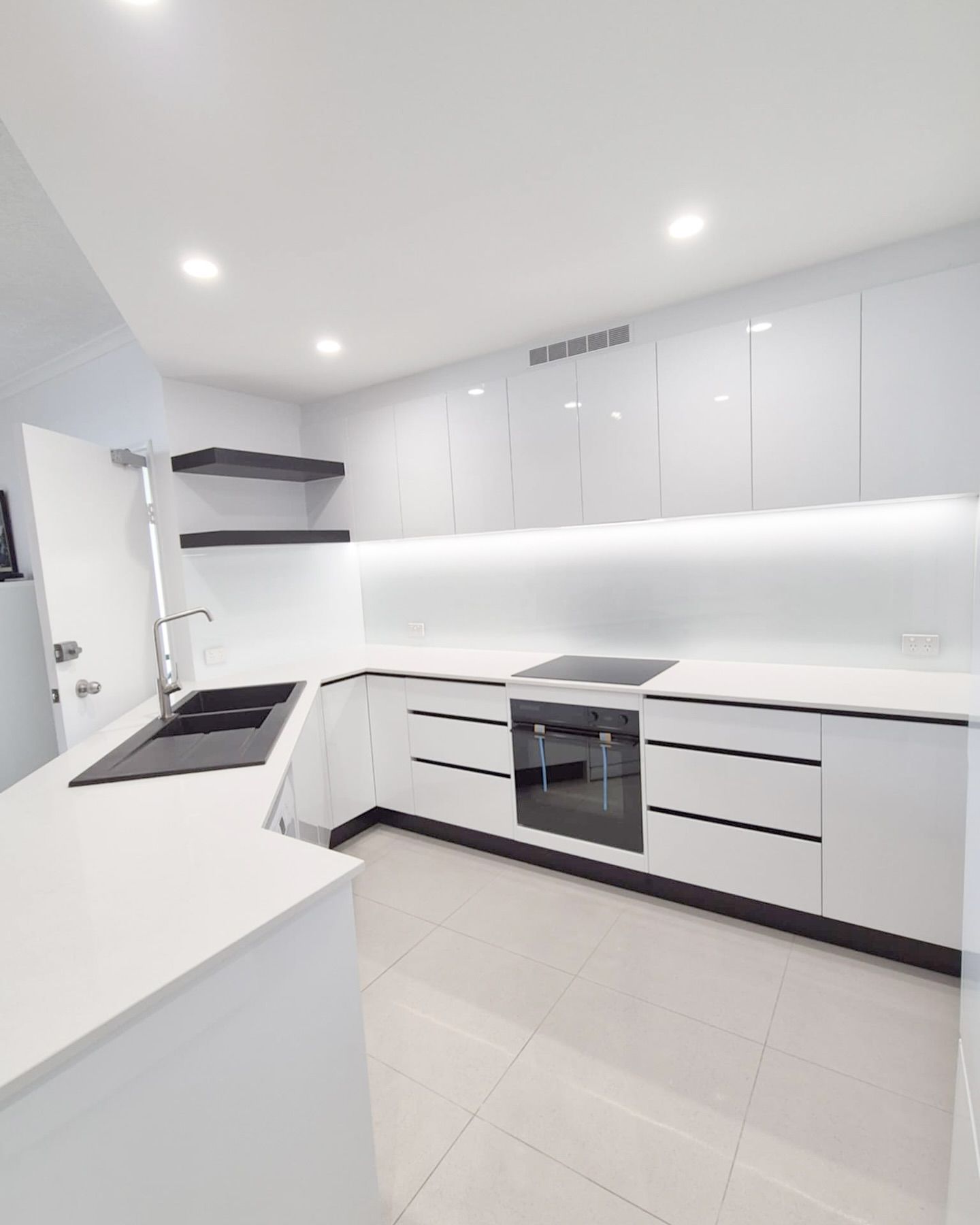 A Kitchen With White Cabinets , A Sink, And A Stove — Reynolds Built In Dicky Beach, QLD