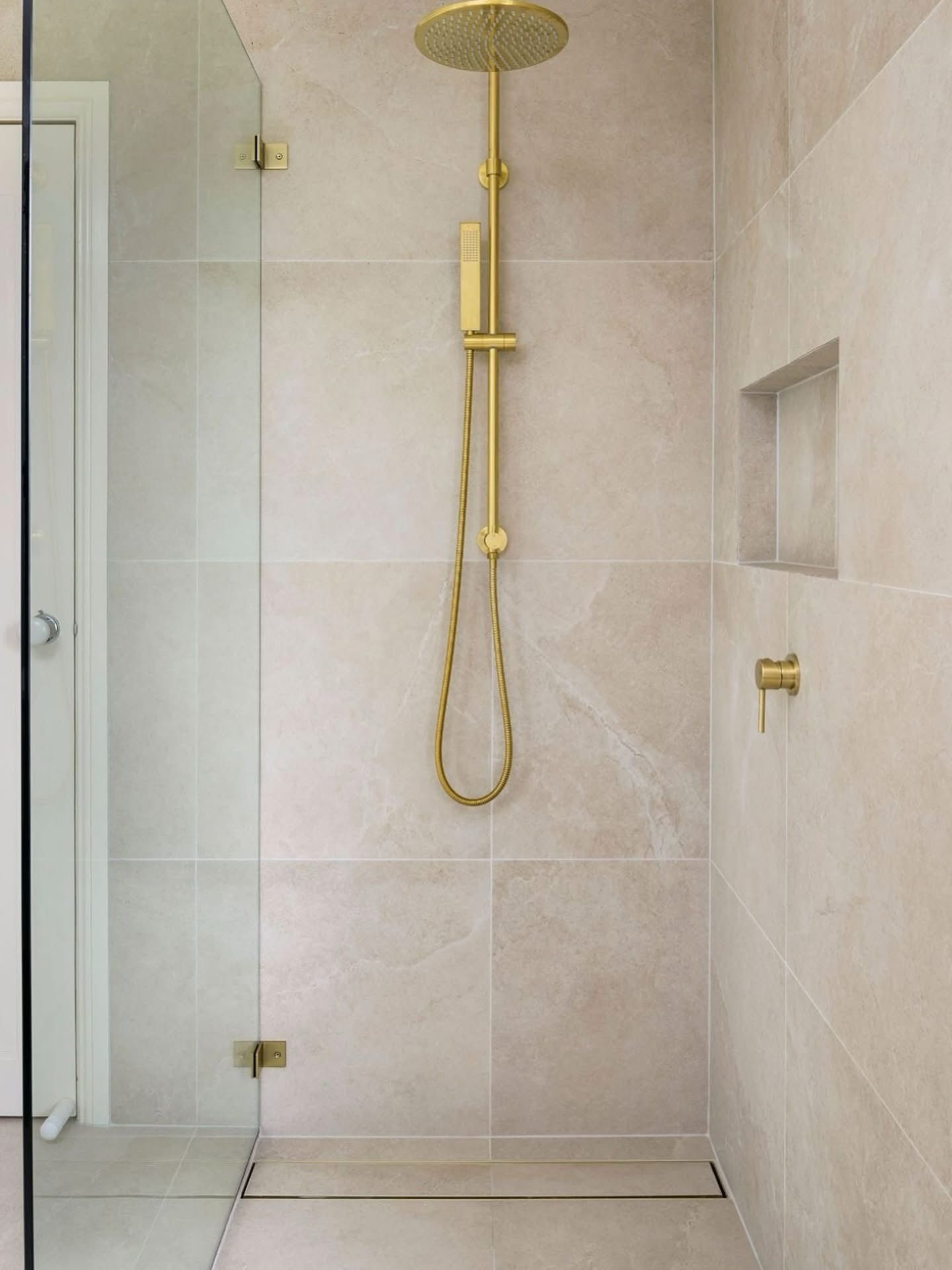 A Shower With Marble-like White and Beige Tiles — Reynolds Built In Dicky Beach, QLD