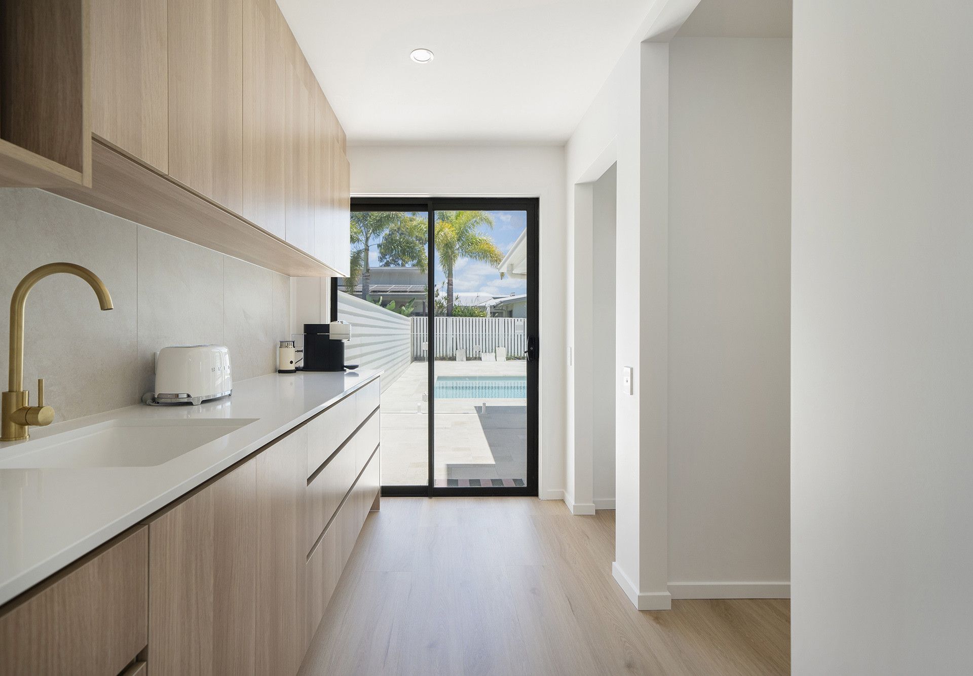 Open-plan Kitchen and Dining Area With Light Wood Floors — Reynolds Built In Dicky Beach, QLD