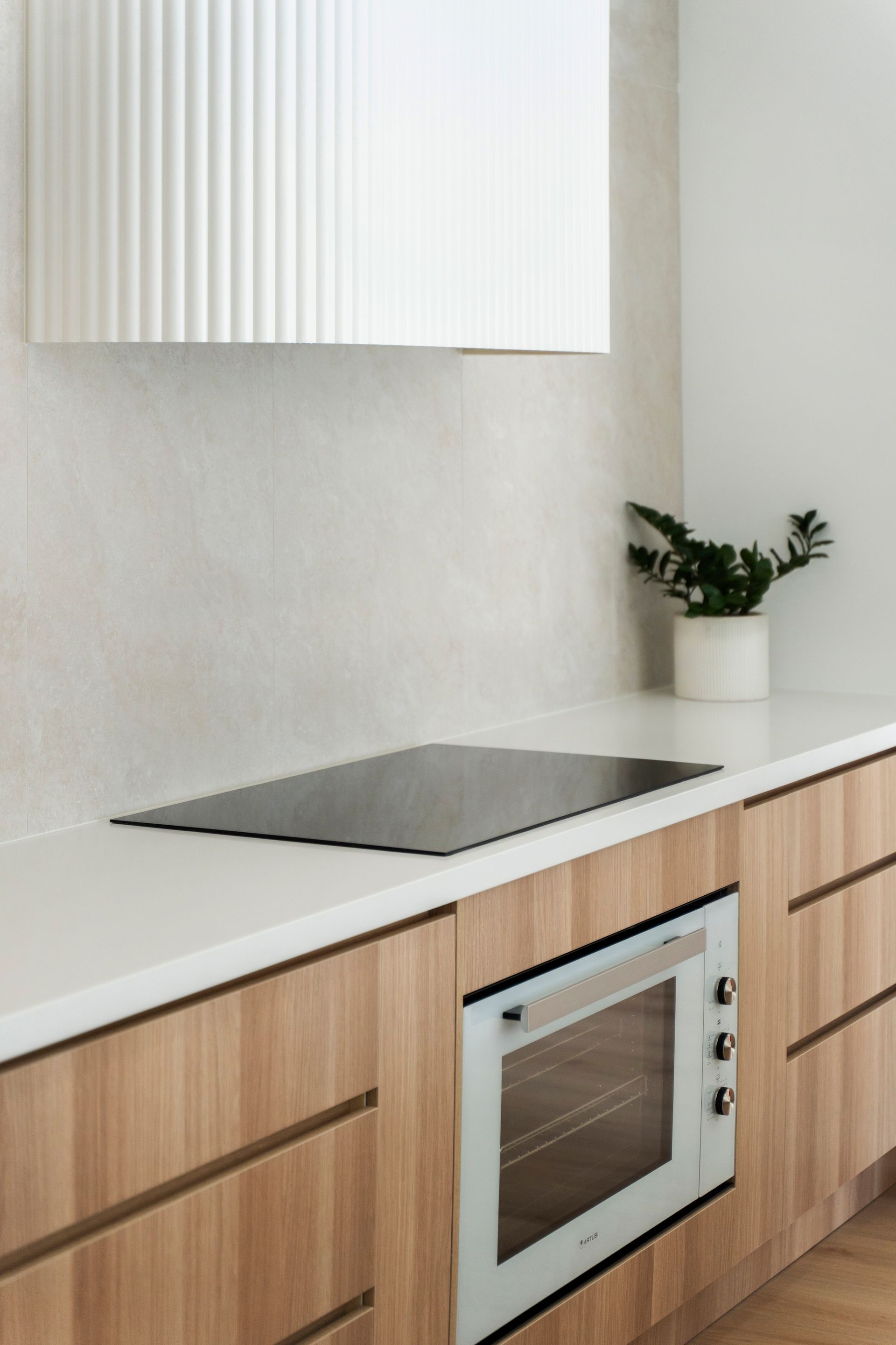Modern Kitchen With Light Wood Cabinets, and a White Countertop — Reynolds Built In Dicky Beach, QLD