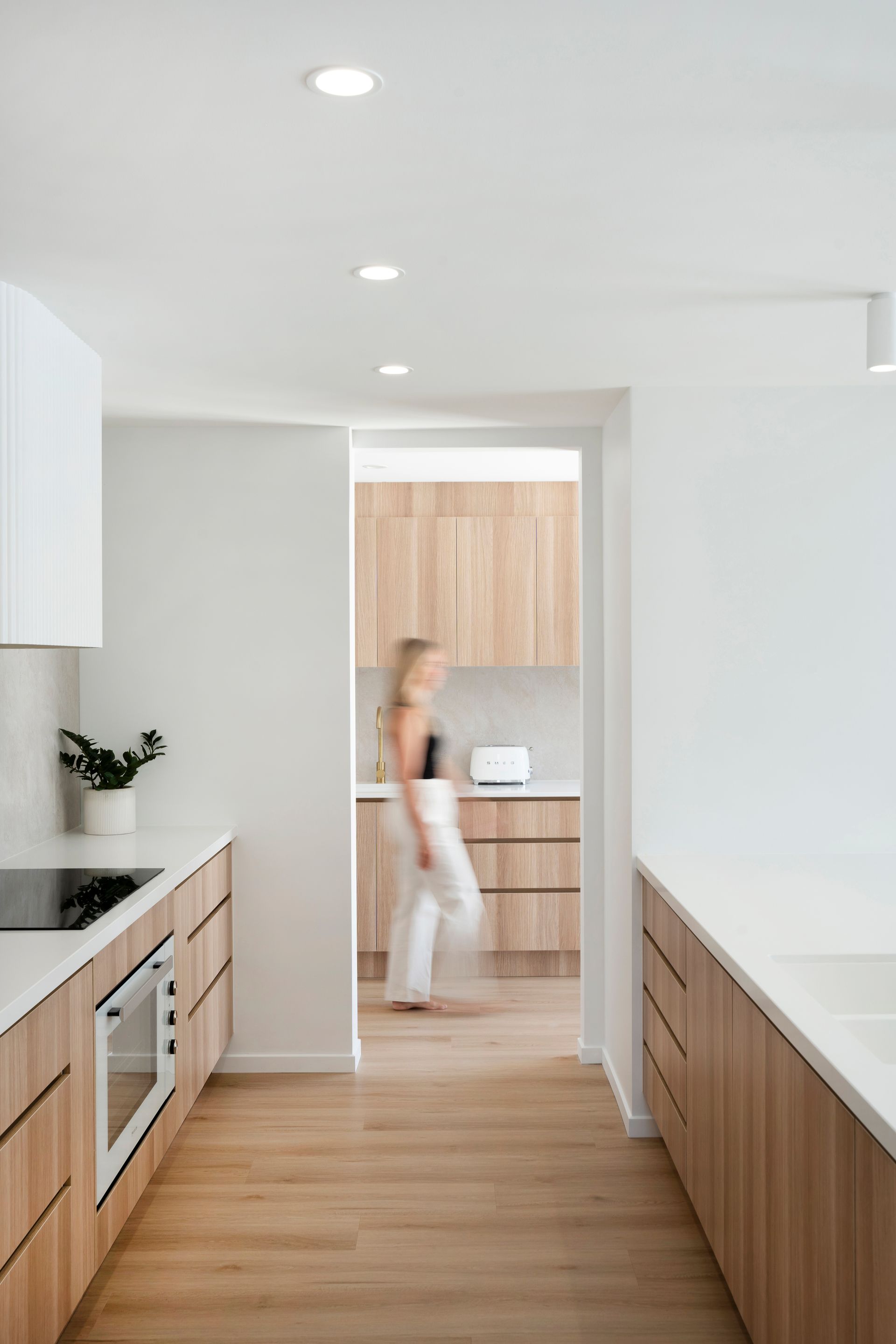 A Kitchen With Wooden Cabinets And White Counter Tops — Reynolds Built In Dicky Beach, QLD