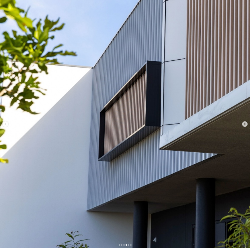 Modern Building Facade Featuring Corrugated Grey Metal Cladding — Reynolds Built in Moffat Beach, QLD
