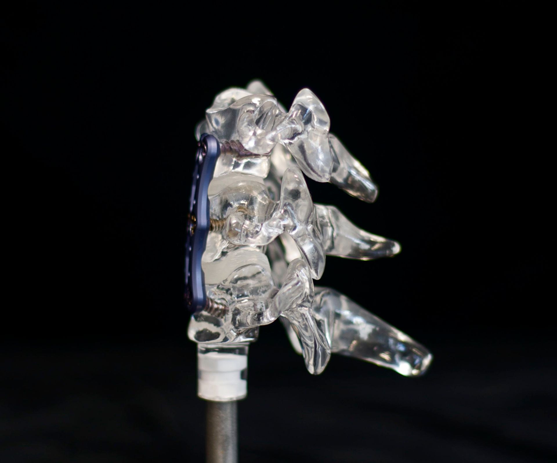 A close up of a clear object on a black background.