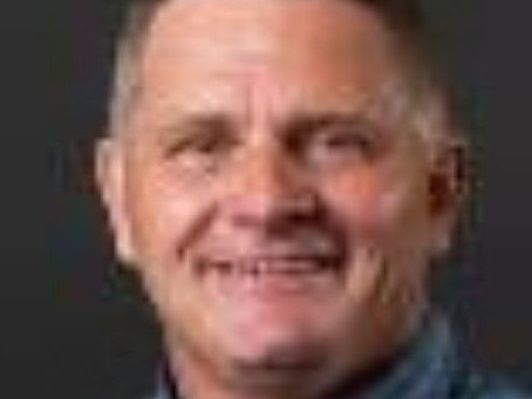 A close up of a man 's face with a smile on his face.