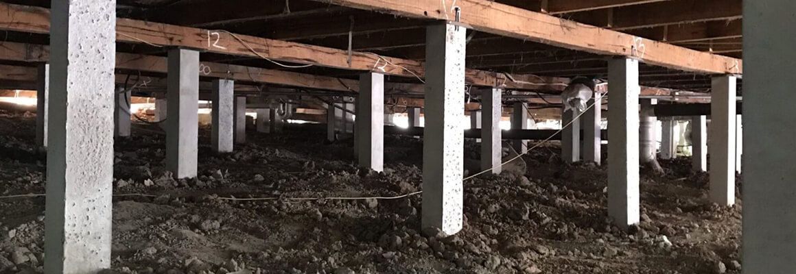 A black and white photo of the foundation of a house.