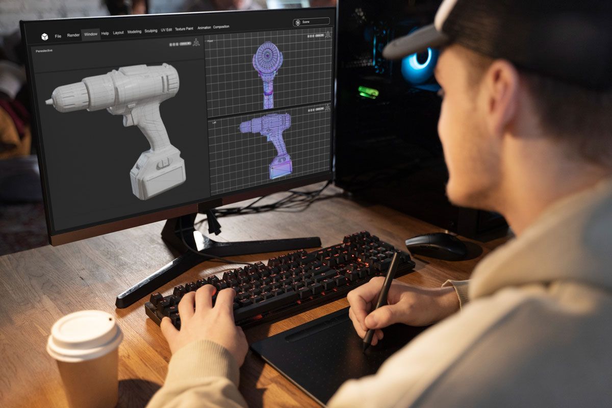 Designer modelling a cordless drill in 3D on a workstation.