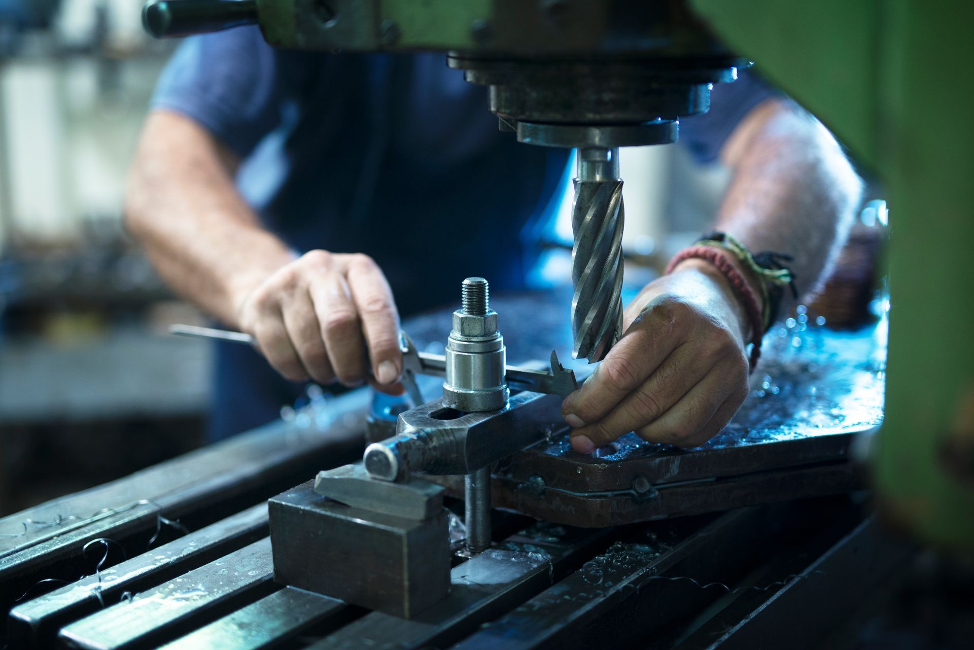 Machinist setting up a workpiece under a milling cutter.