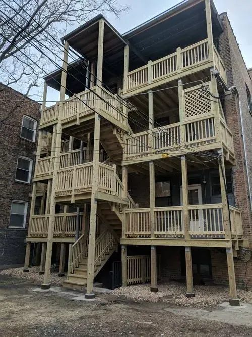 A building with a lot of wooden decks and stairs.