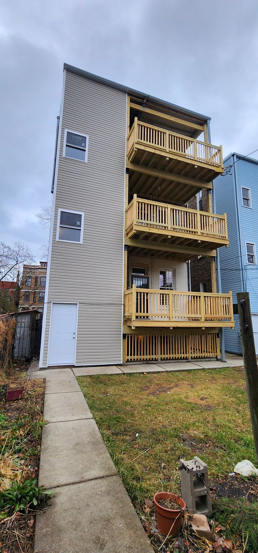 A large apartment building with a wooden deck and balconies.