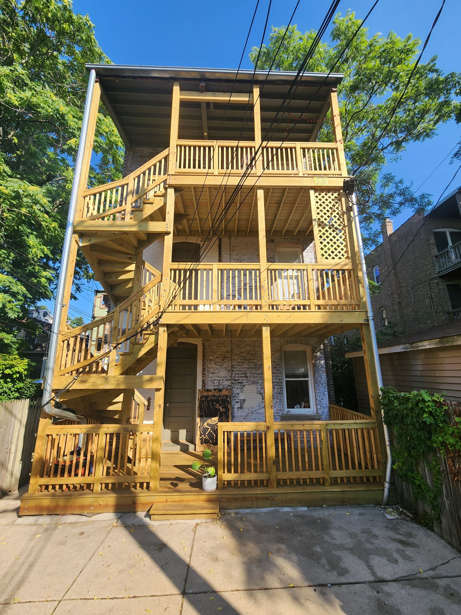 A large house with a wooden deck and stairs.