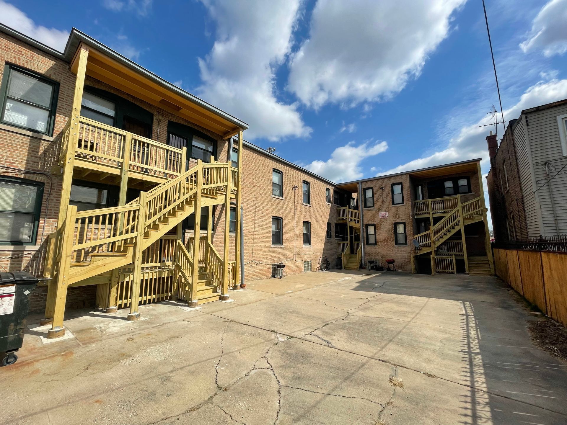 A large brick building with stairs leading up to the second floor.