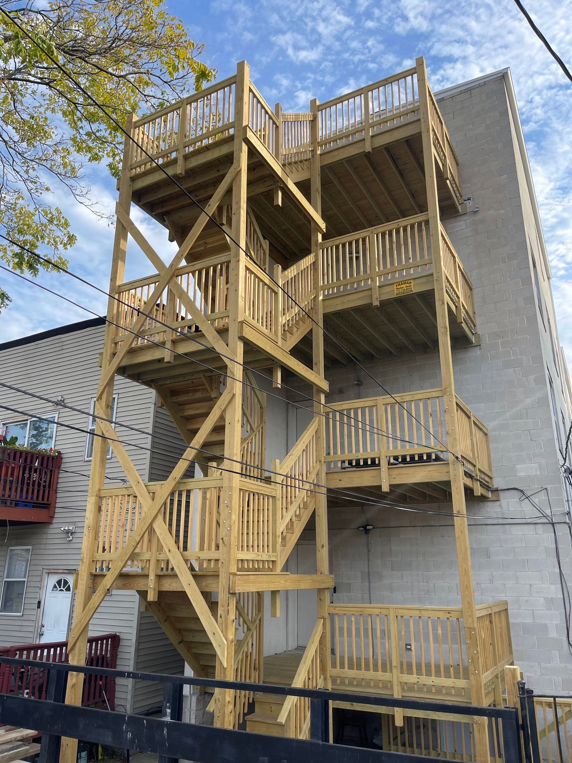 A wooden fire escape is being built on the side of a building.