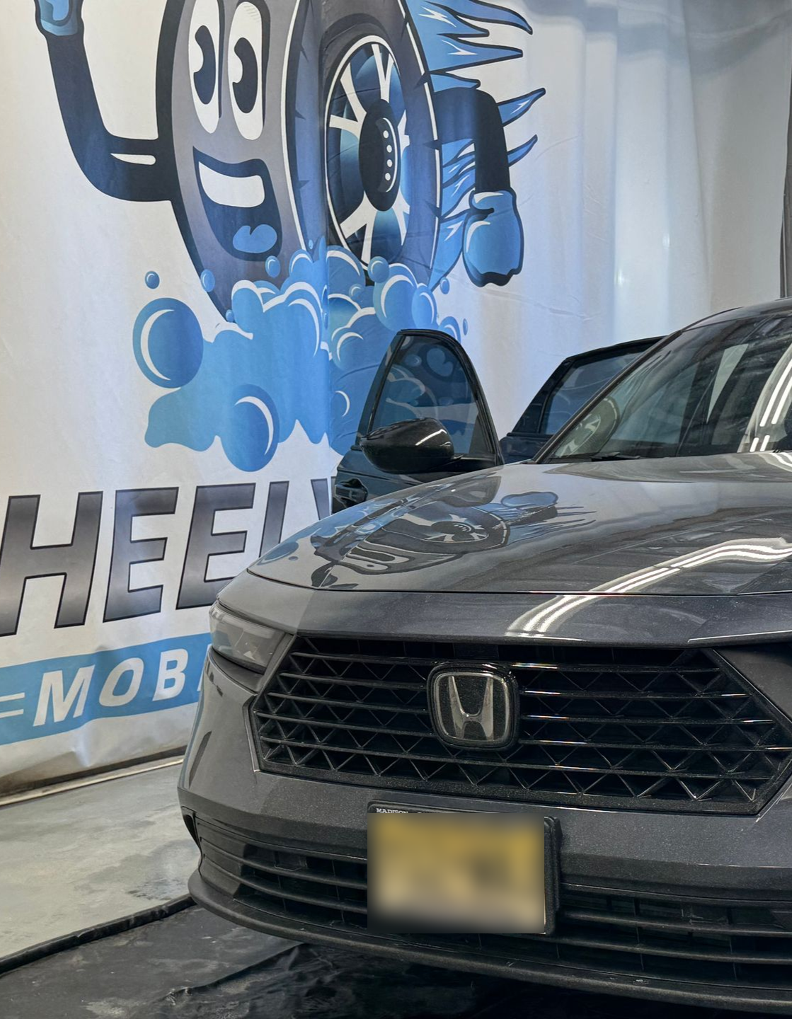Gray Honda Accord at a car wash, license plate 