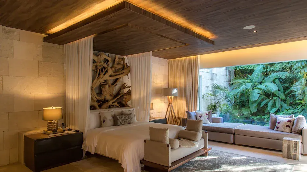 Luxury villa with pool and mountain view, surrounded by tropical plants.