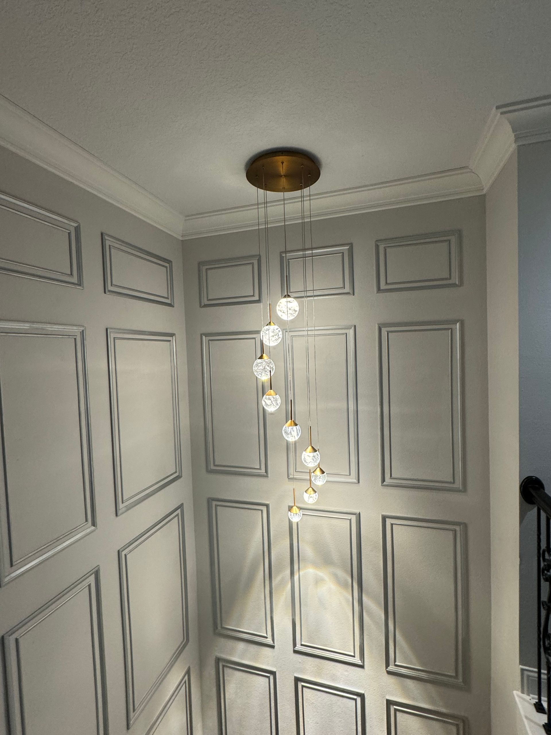 A ceiling light is hanging from the ceiling in a hallway.