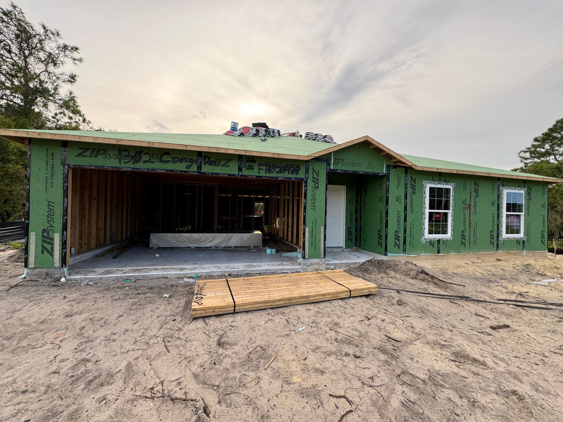 A house is being built in the middle of a dirt field.