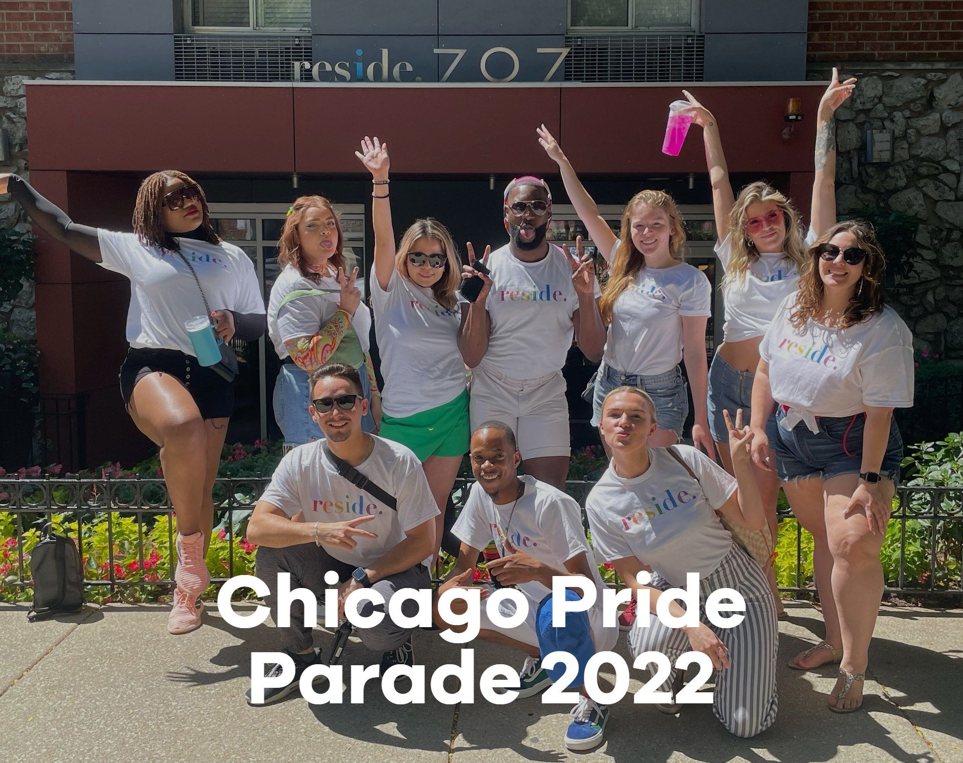 A group of people are posing for a picture in front of a building.