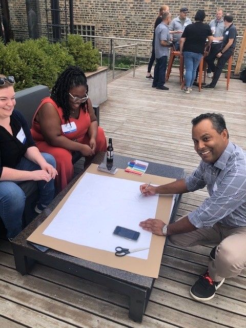 A group of people are sitting around a table with a piece of paper on it