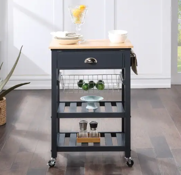 A dark grey rolling kitchen cart with a light wood top, one drawer, a wire basket, and two slatted storage shelves.