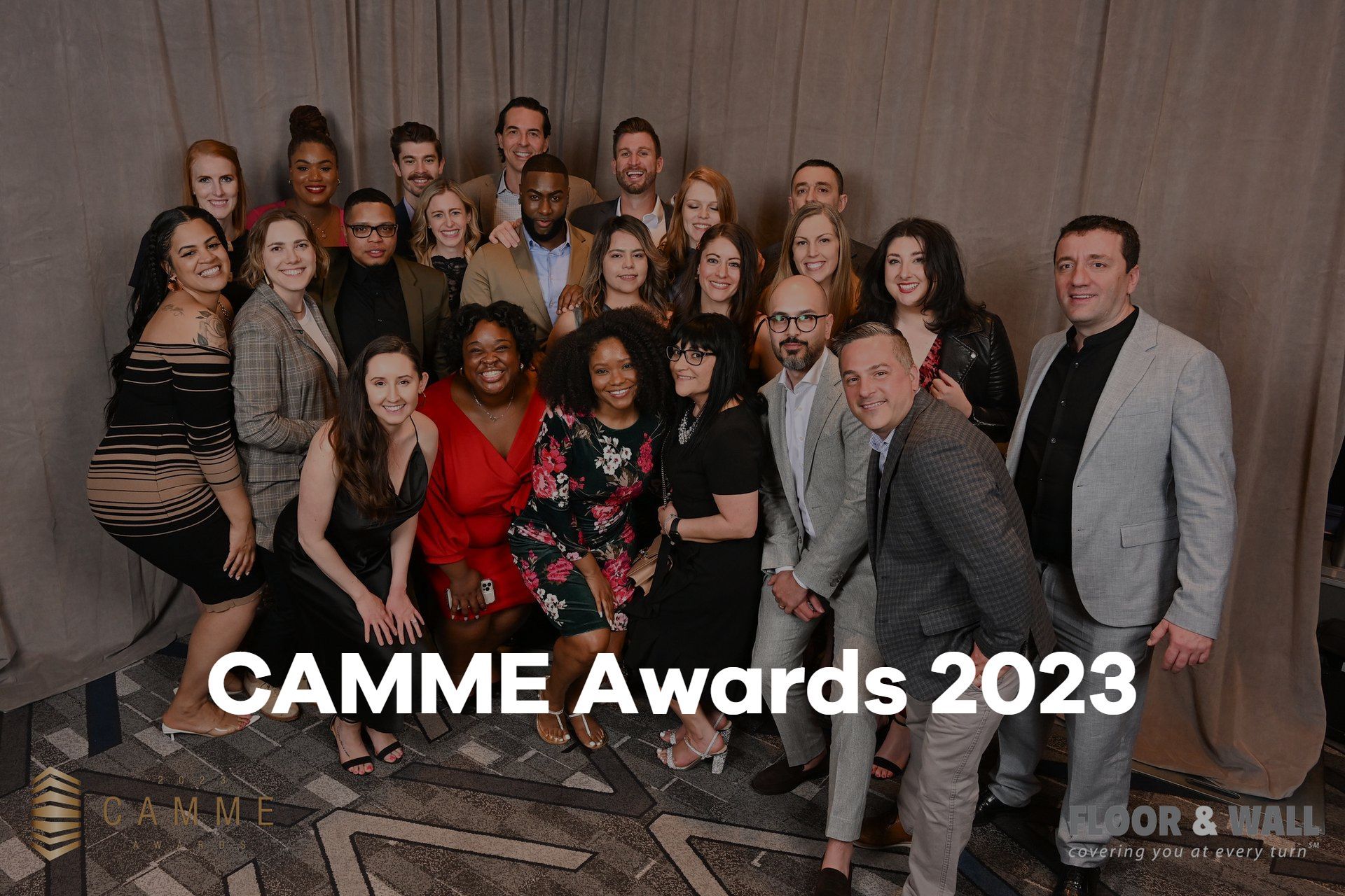 A group of people are posing for a picture at the camme awards.