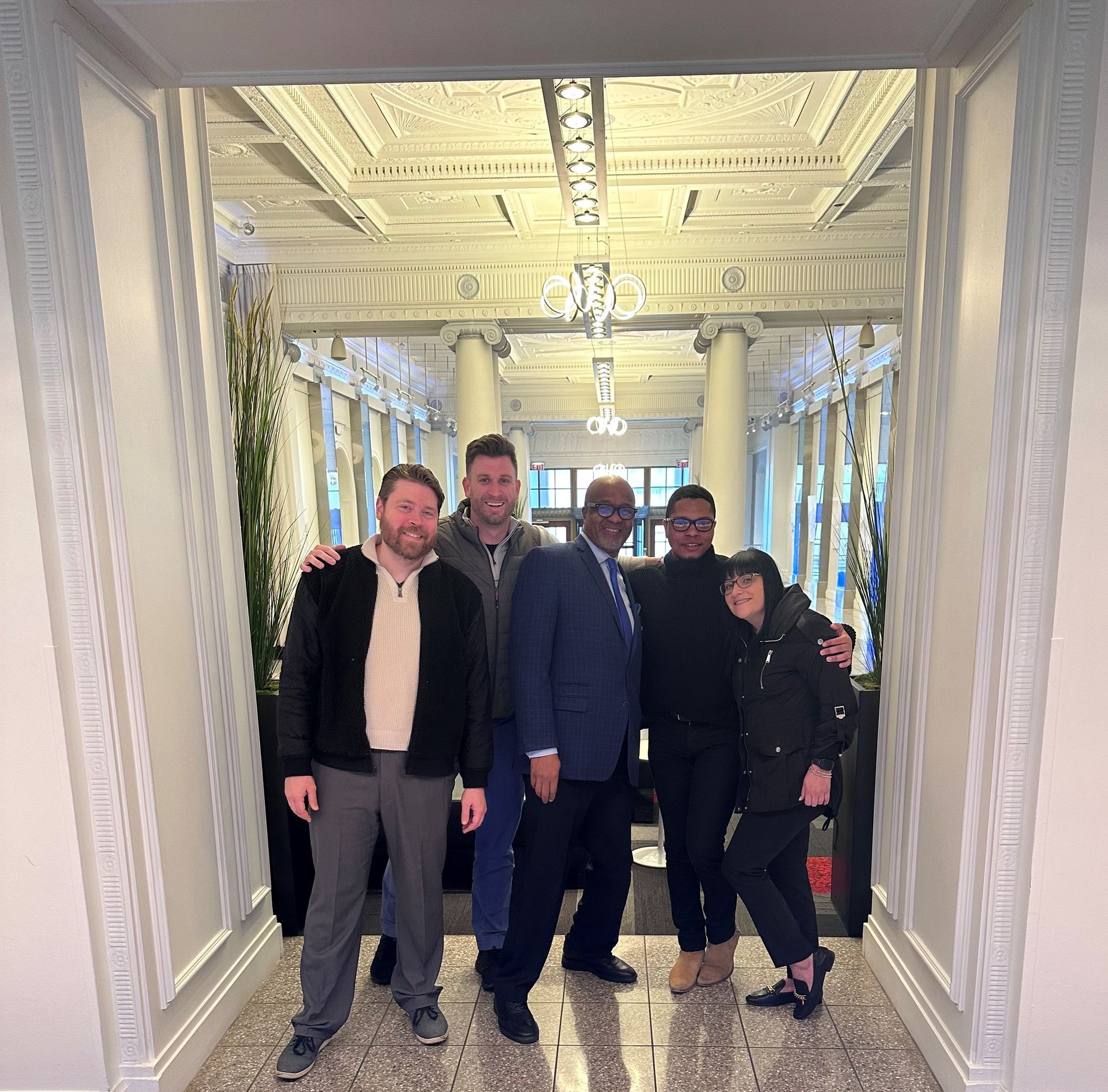 A group of people posing for a picture in a hallway