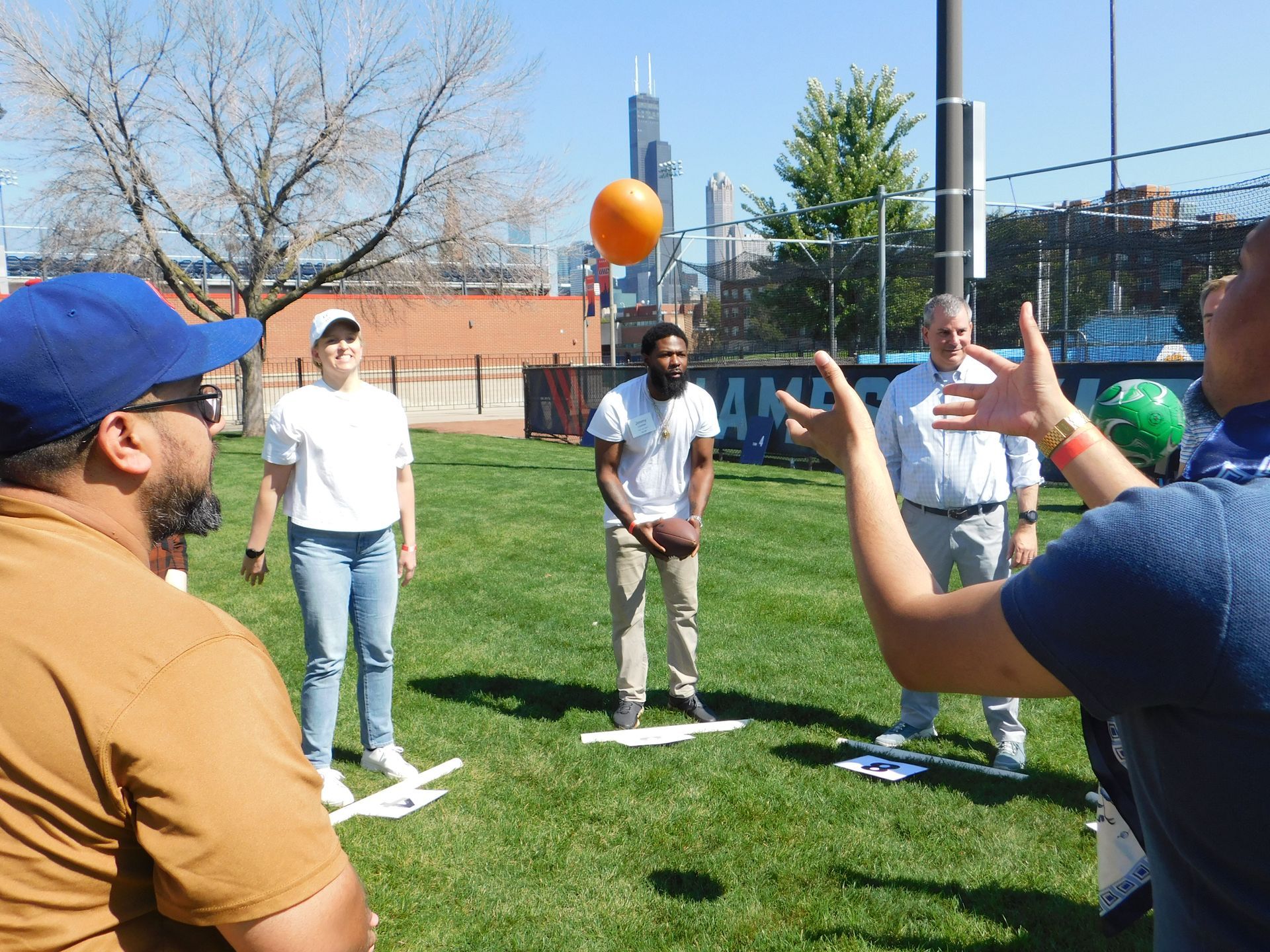 A group of people are playing a game in a park.