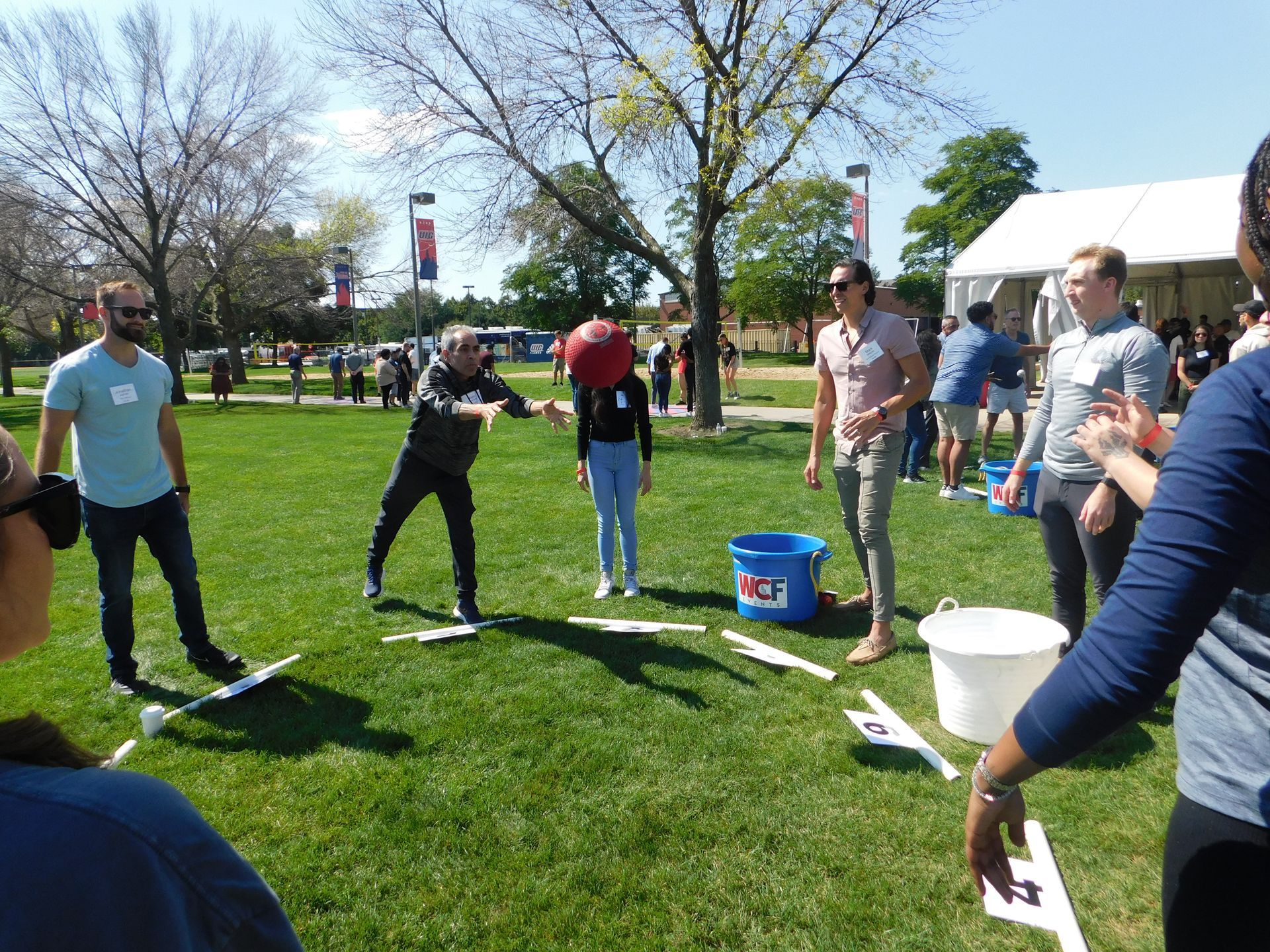 A group of people are playing a game in a park.