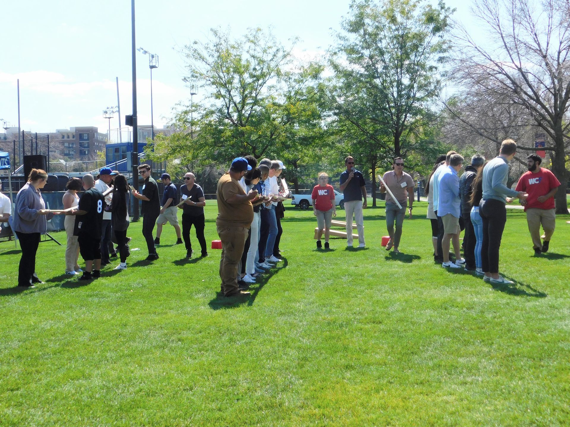 A group of people are standing in a grassy field