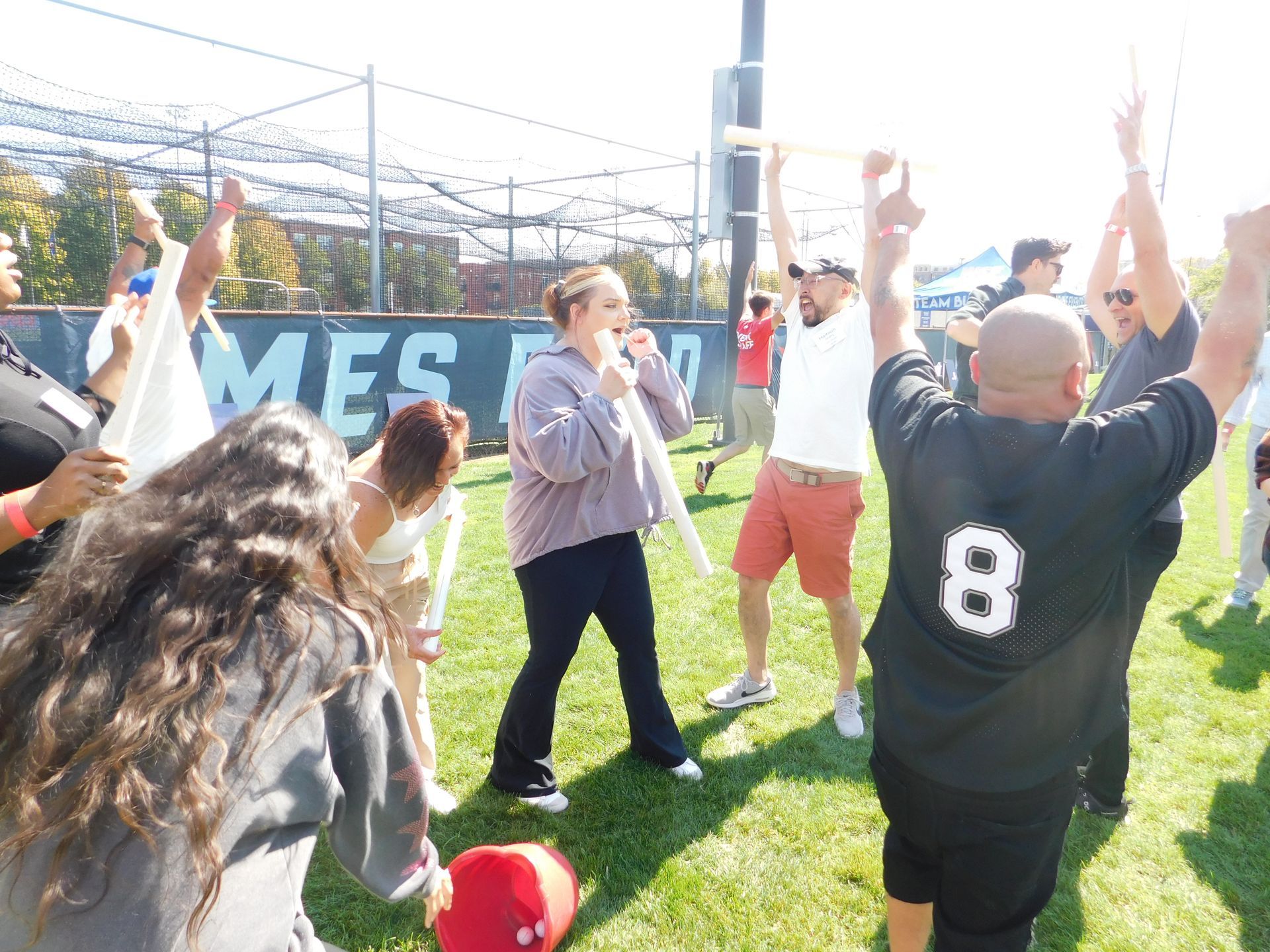 A group of people are standing on a field with a man wearing a number 8 jersey
