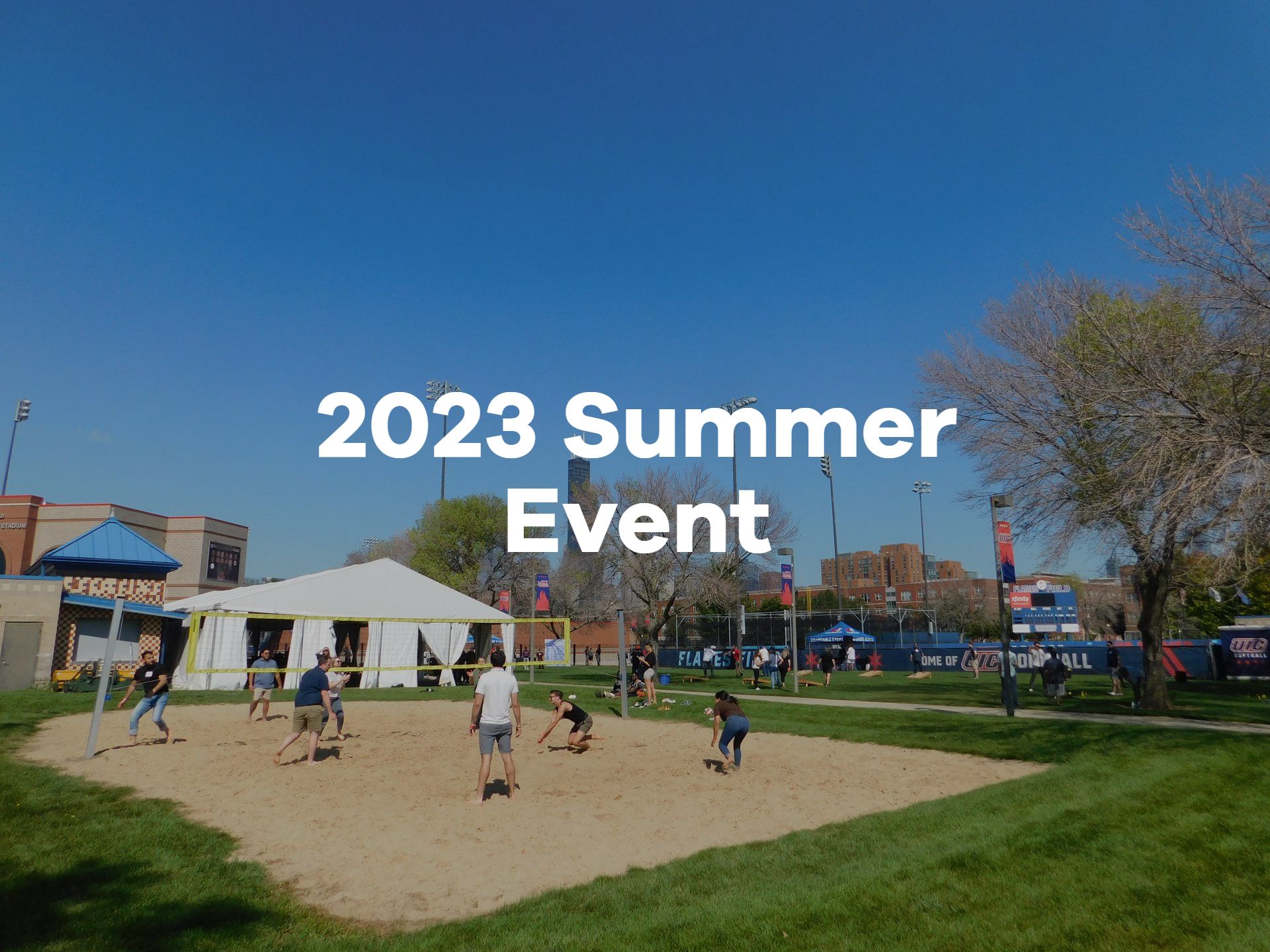 A group of people are playing volleyball in a park.