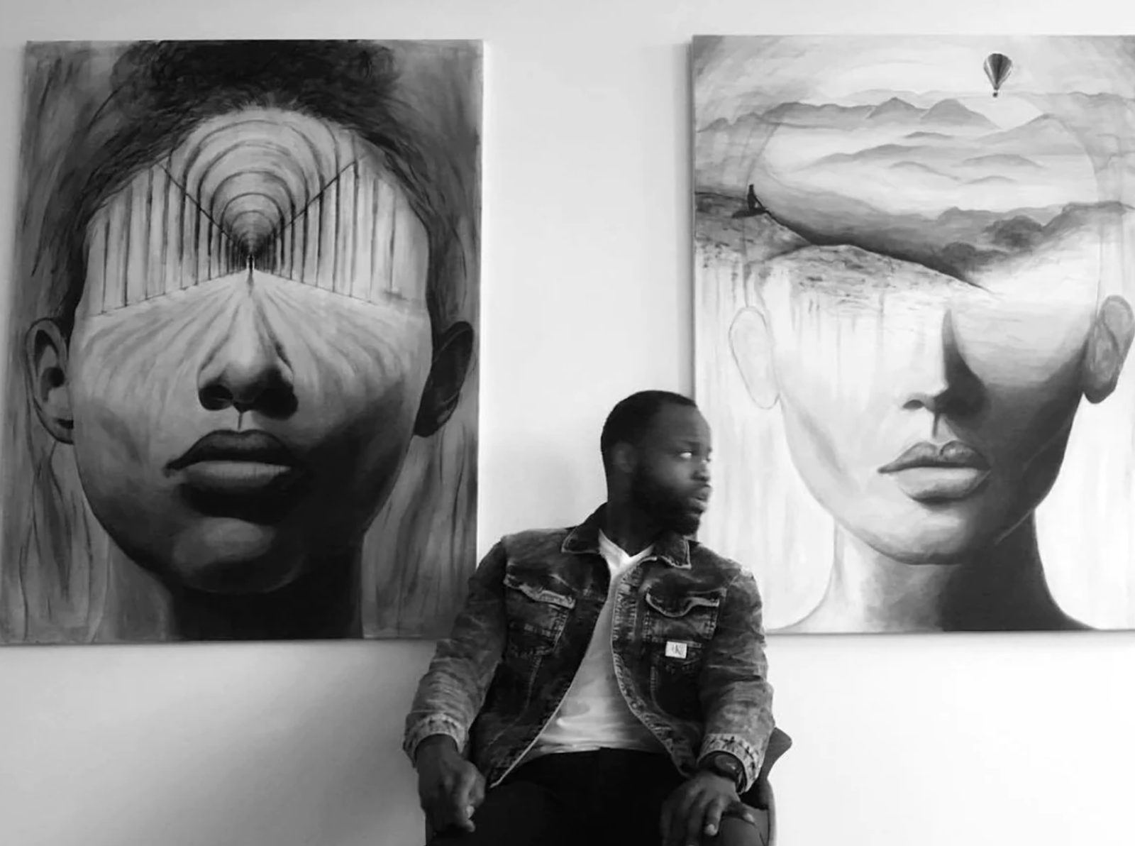 Artist Adonte Clark with two of his paintings show female faces with landscapes