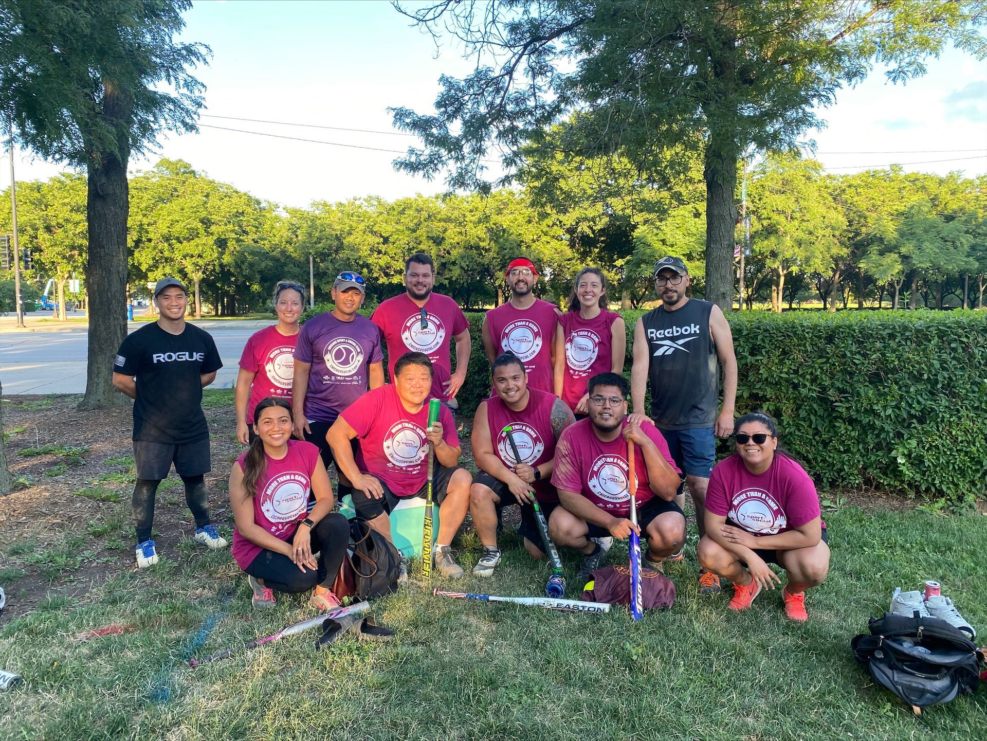 A group of people are posing for a picture in a park.